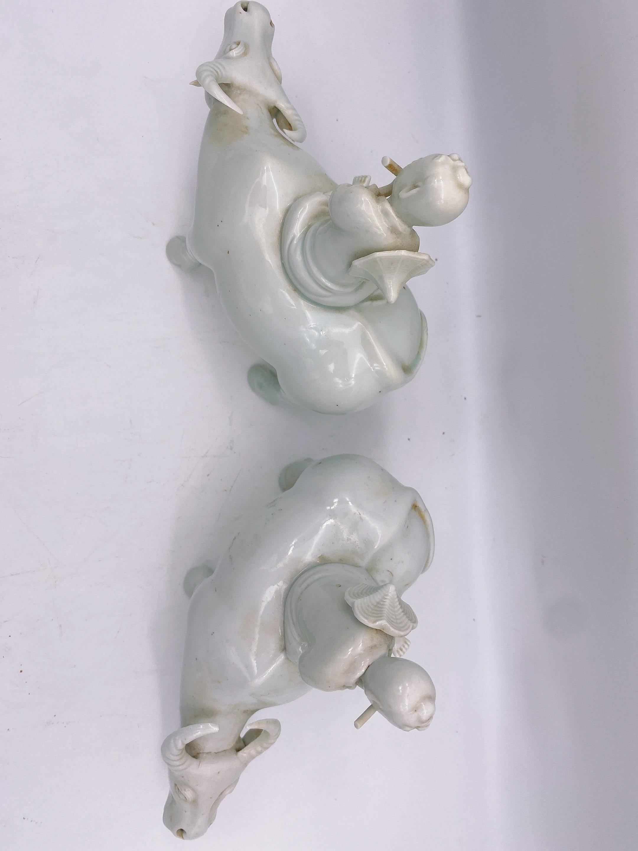 Carved Antique Pair of Chinese Dehua Porcelain Figures of Boys on Water Buffalos For Sale