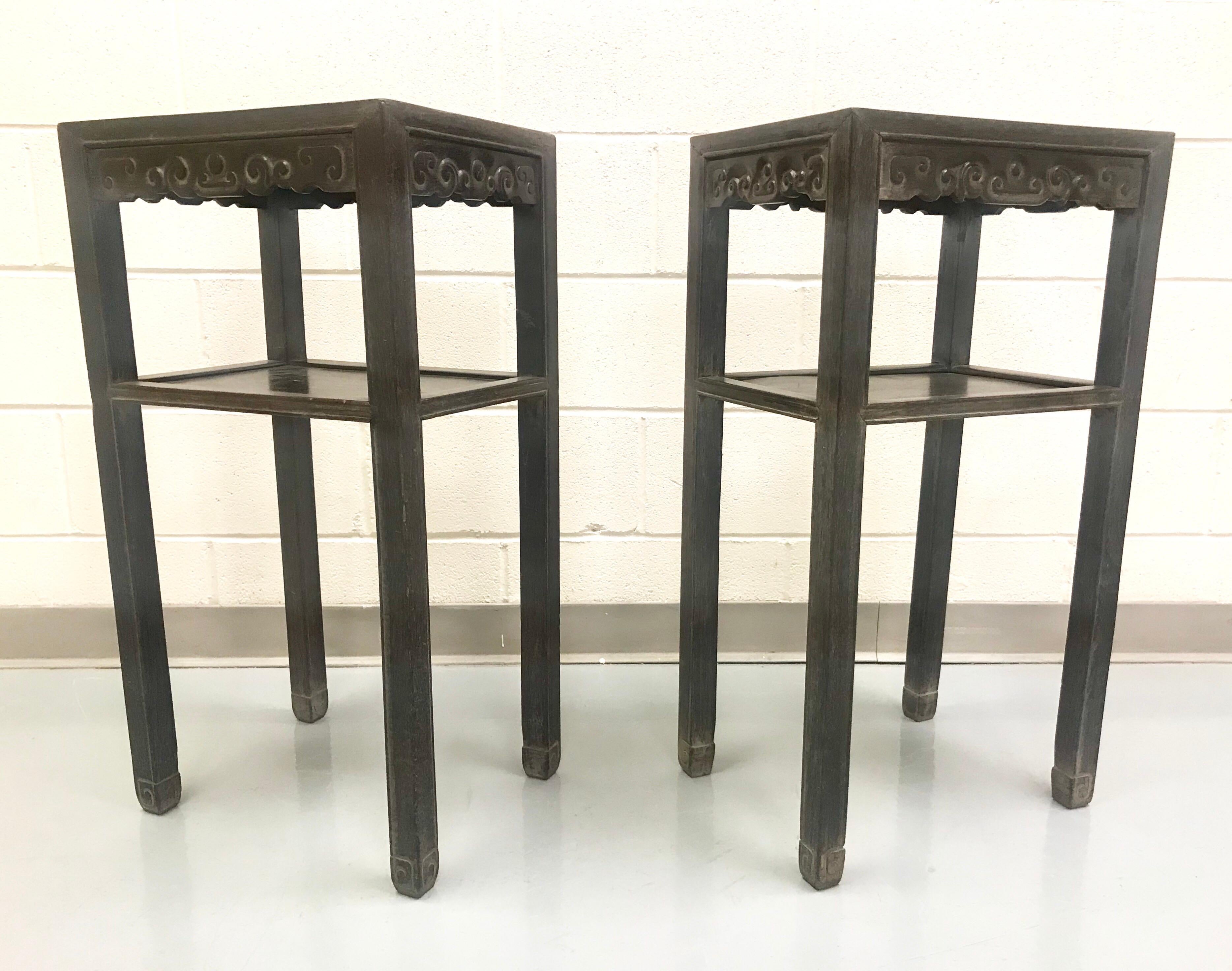 Antique pair of Chinese elm tables having carved panels on each side.