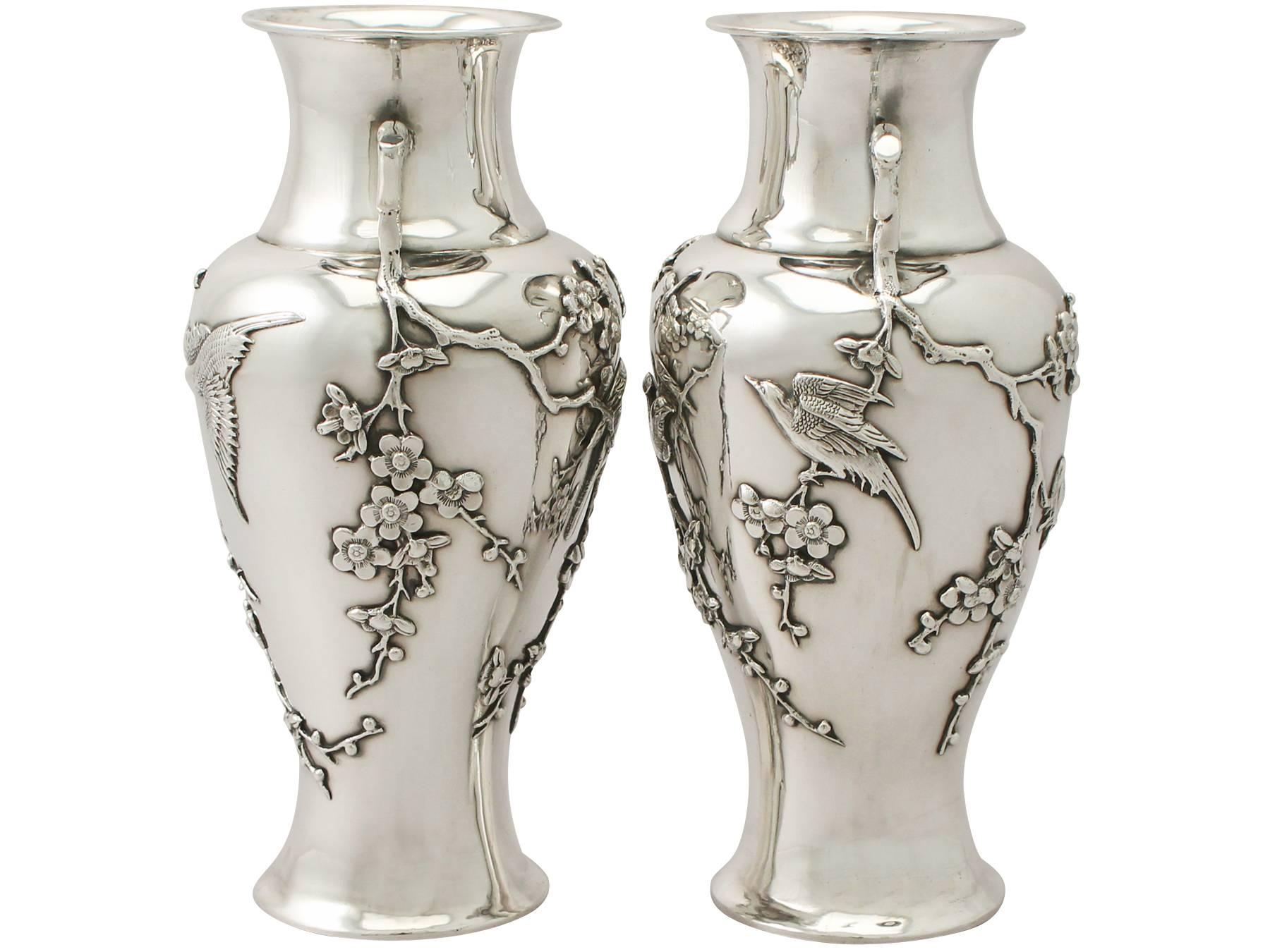 A fine and impressive pair of antique Chinese Export silver vases; an addition to our ornamental silverware collection.

These impressive antique Chinese Export silver vases have a circular rounded, waisted form.

The surface of each vase is