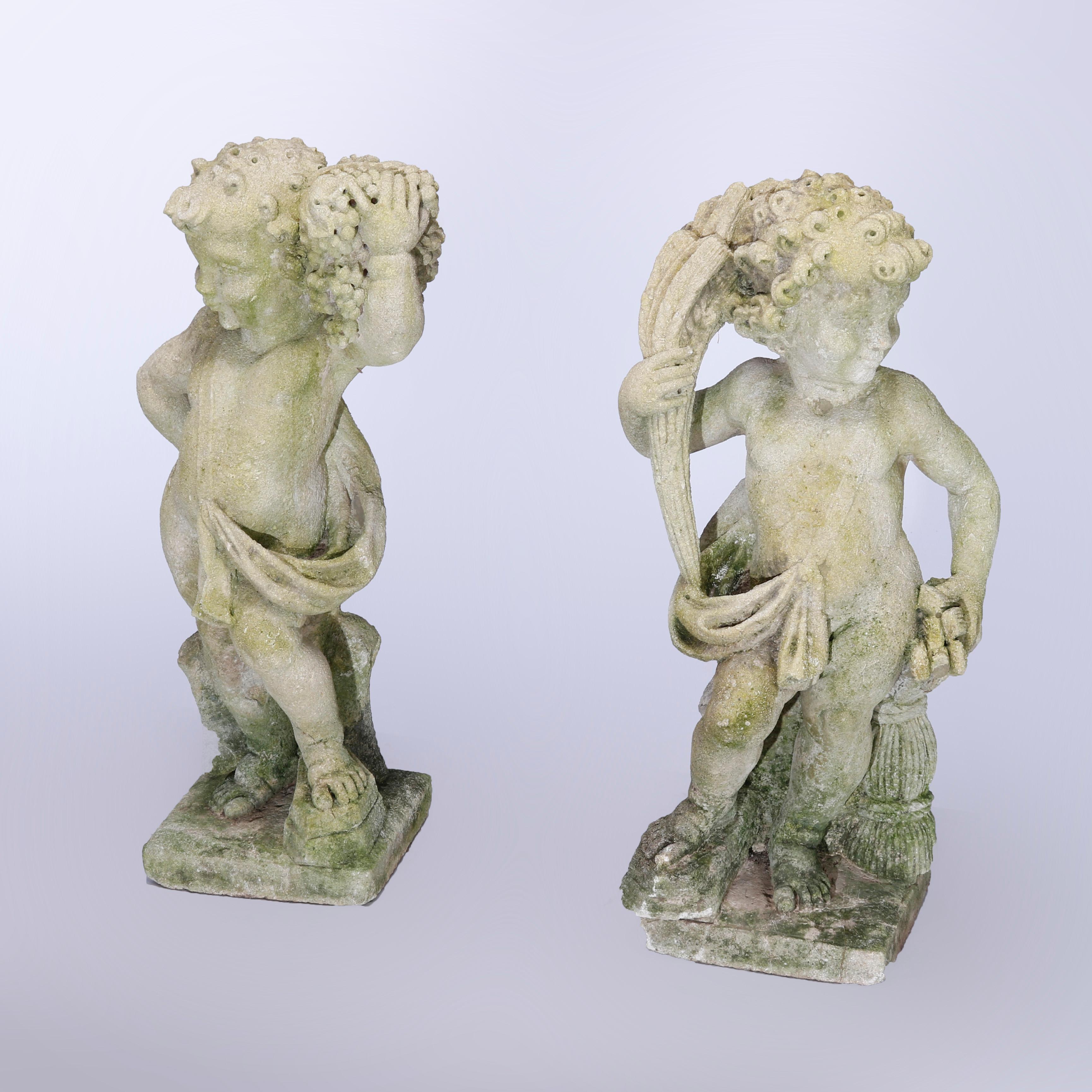 An antique pair of garden statues depict Classical Harvest Cherubs, one with grapes and the other with wheat, c1890

Measures - 29.5''H x 13.75''W x 10''D.