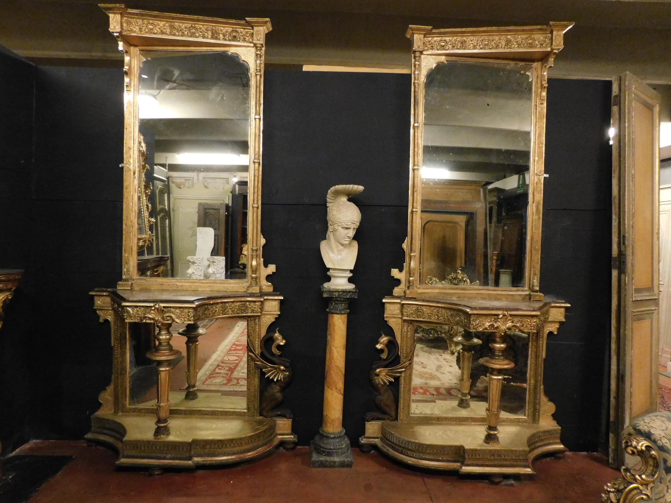 Antique pair of console tables with Gothic neogothic mirror, gold wood, dragons and decorations, at an angle, they had a central door of passage, they are perfect to put in an important entrance or in a luxury room
Measure max height 290 x 143cm