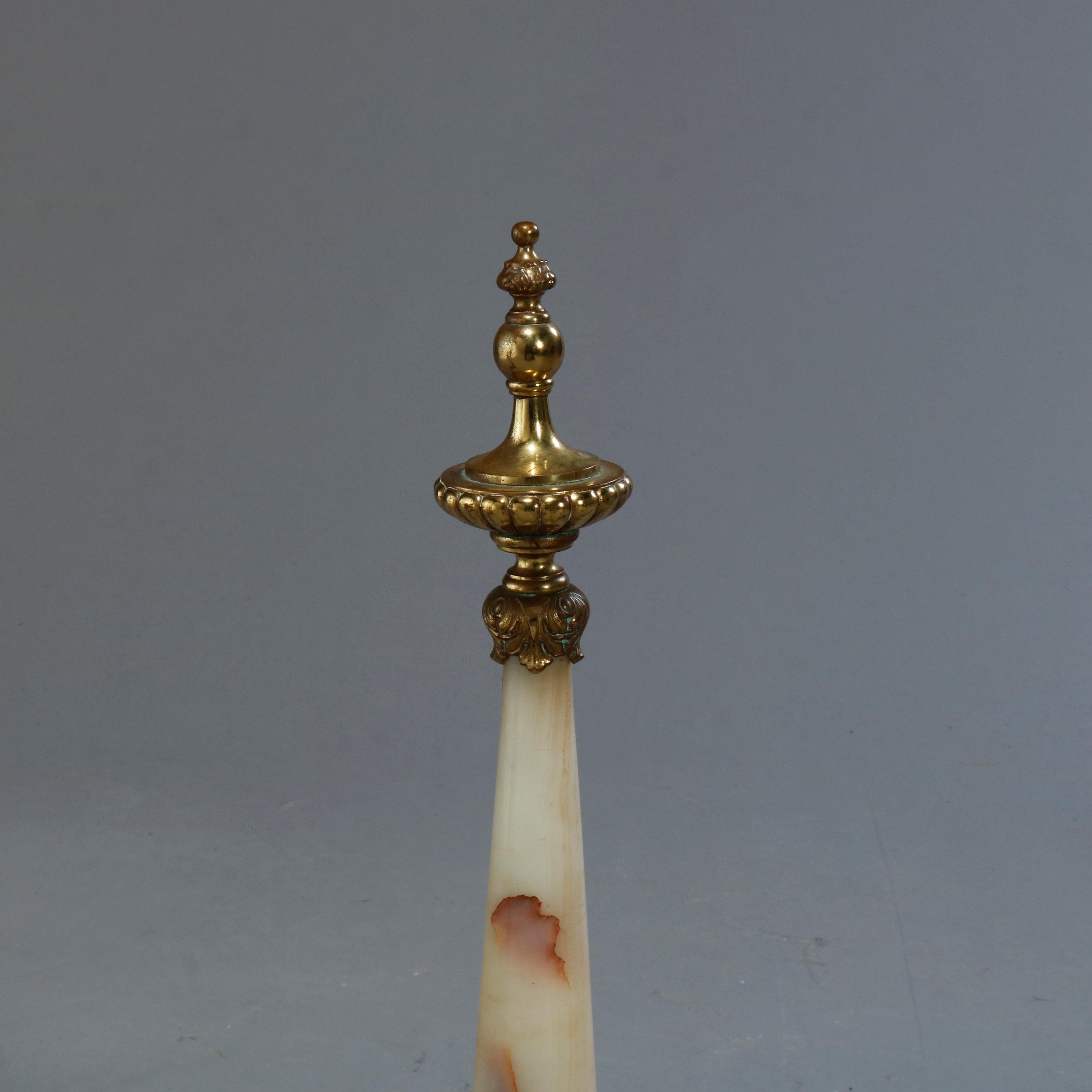 An antique pair of Continental fireplace andirons offer tapered and turned onyx columns with cast brass finial and base, c1900

Measures: 20.5