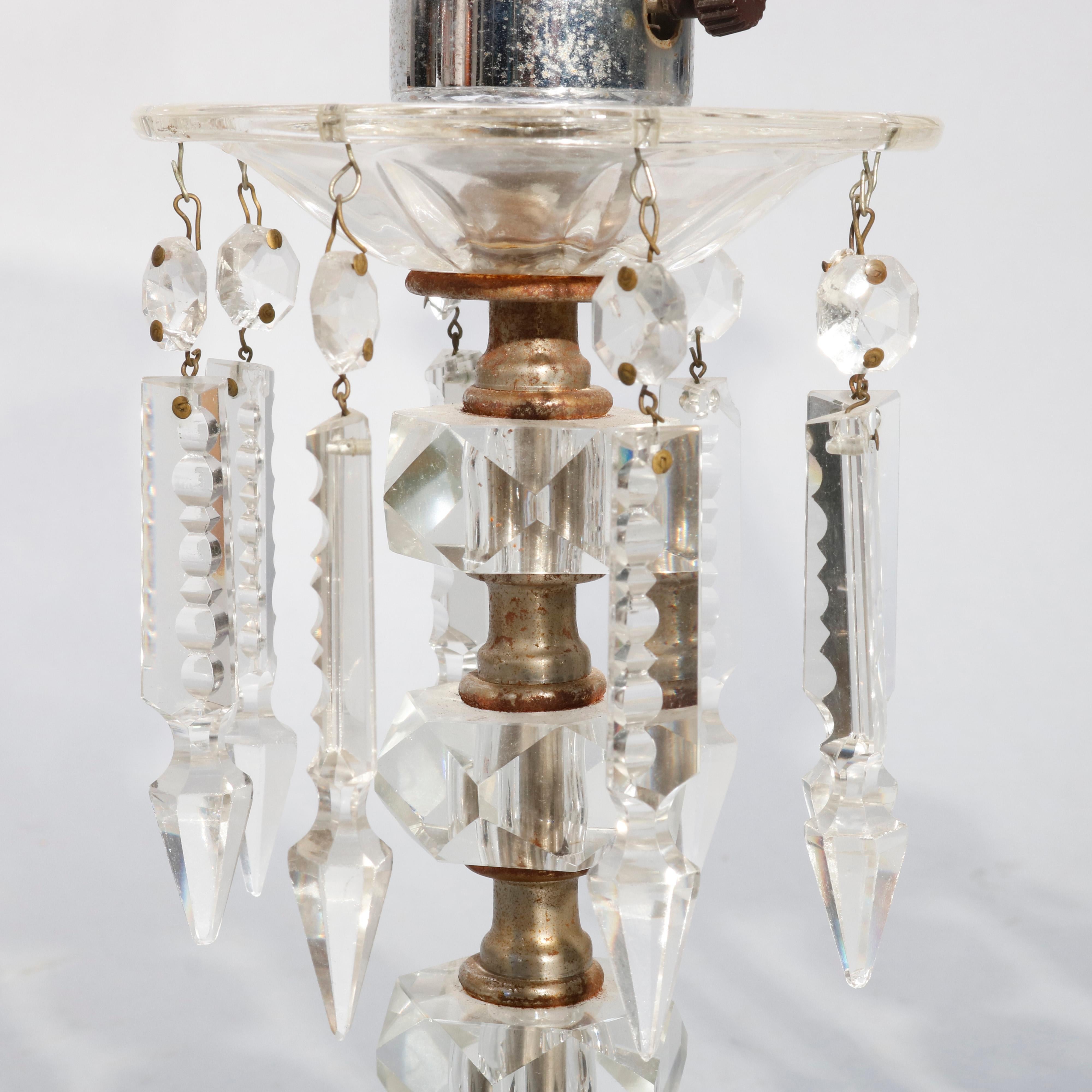 An antique pair of candelabra table lamps offer crystal balustrade form with hanging cut crystal highlights, electrified, circa 1930

Measures - 16.25