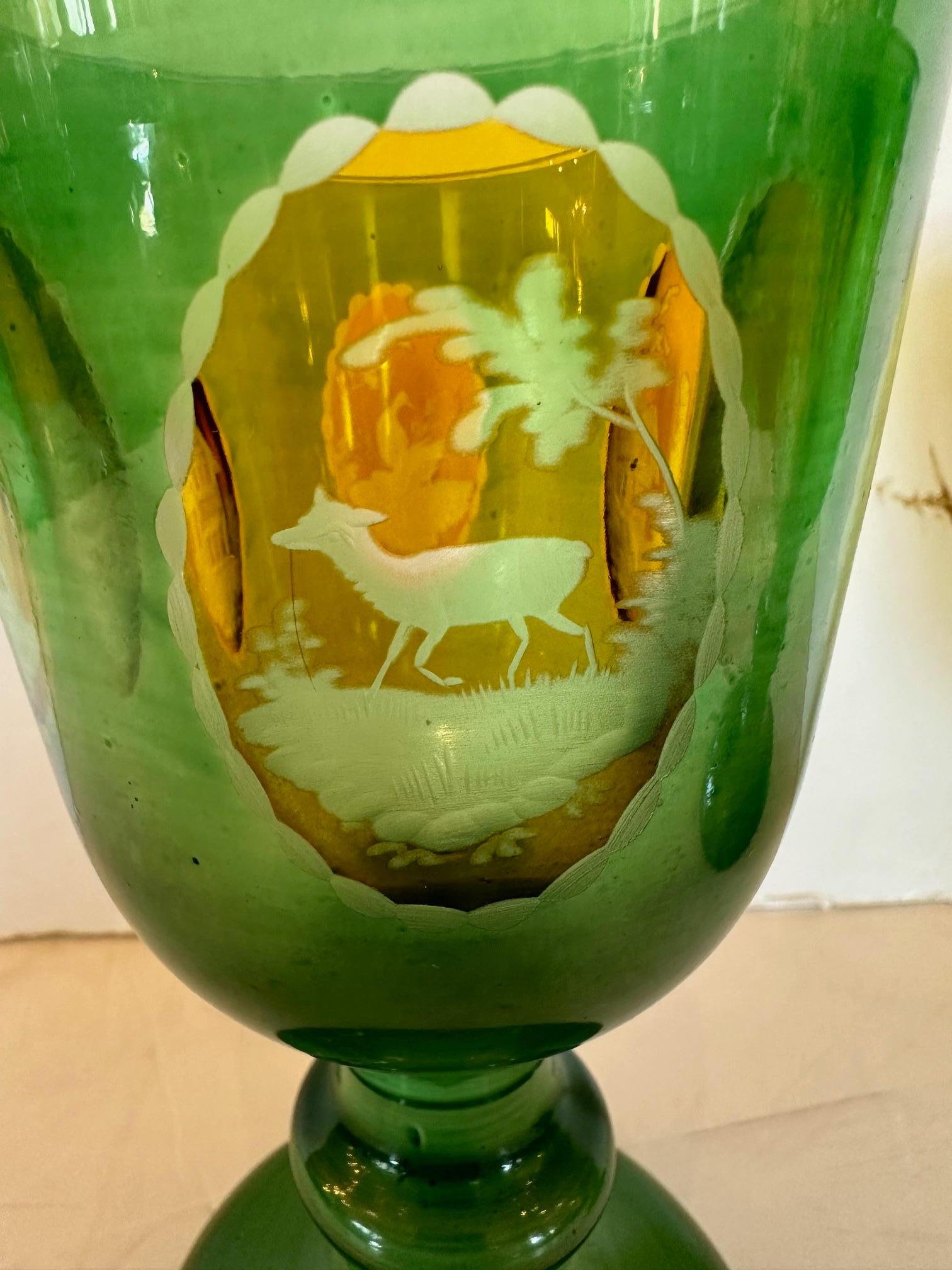 Pair of Antique 19th century Bohemian Overlay Glass Goblets       The Goblets  have a brilliant green coloring and offer four yellow intaglio panels depicting architecture and wildlife scenes.   
Made in Czech Republic 