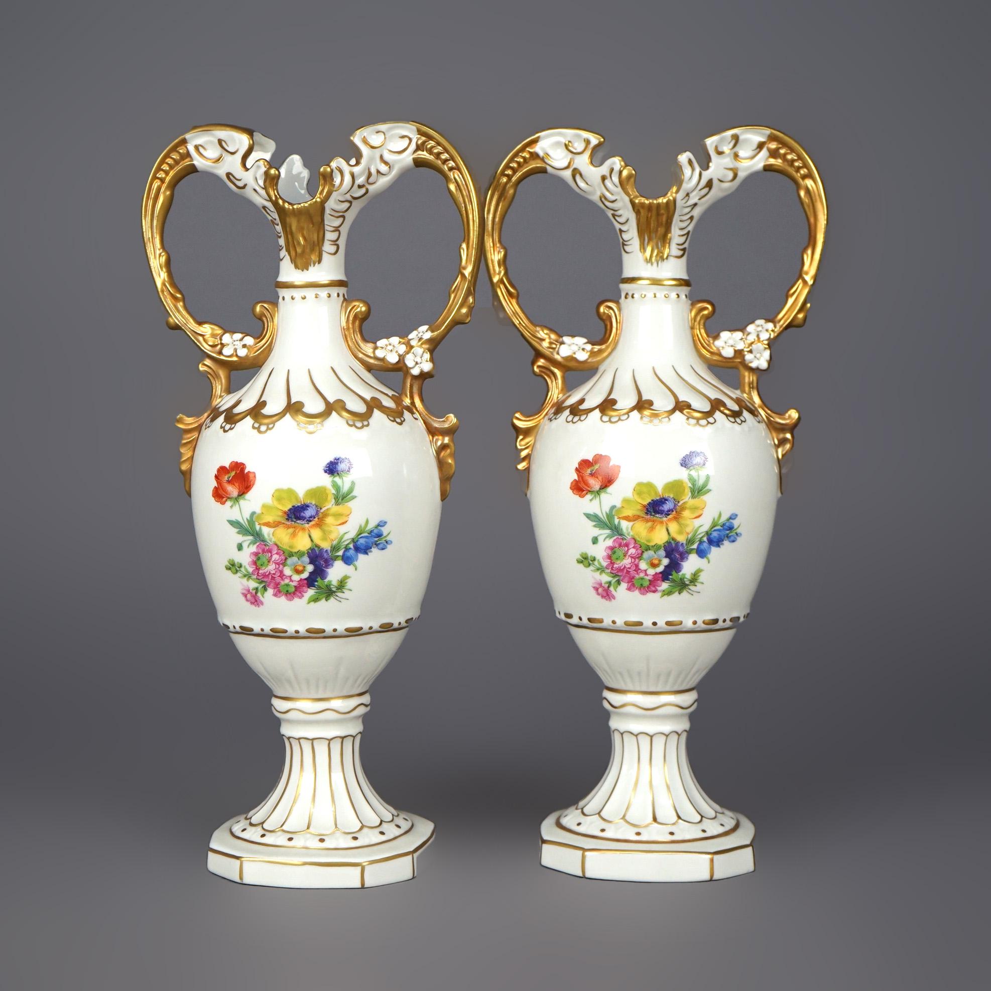 An antique pair of Czech urns offer porcelain construction with double handles, hand painted floral decoration and gilt highlights throughout, stamped on base as photographed, c1940.

Measures- 11.25''H x 5.5''W x 3.5''D.