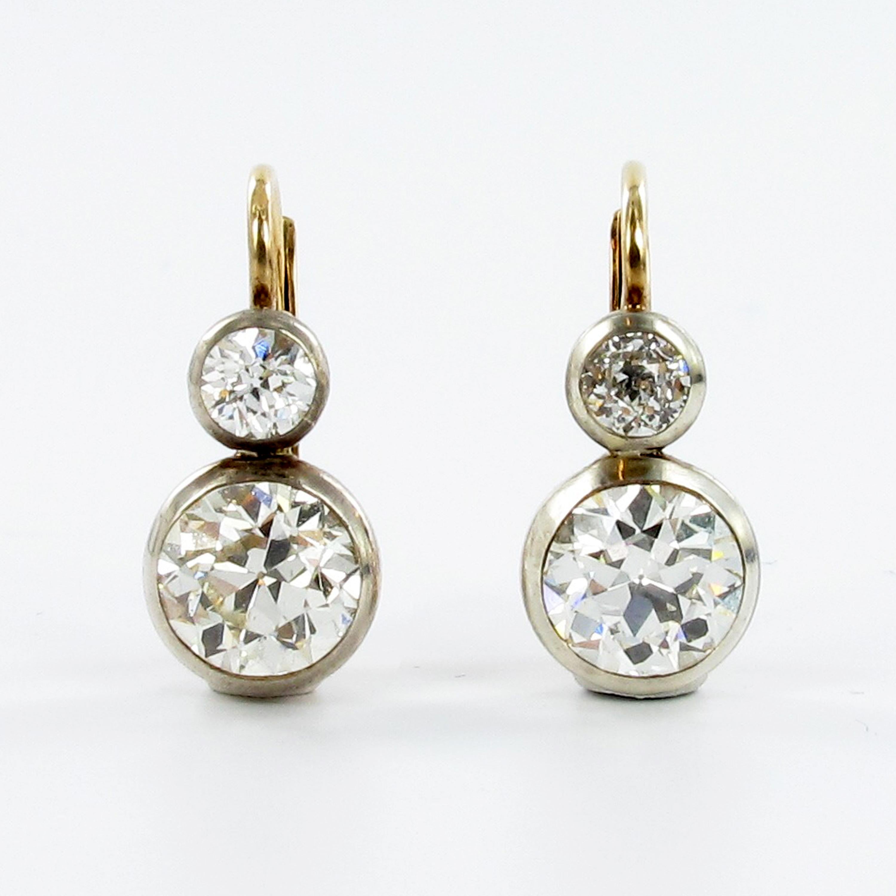 Pair of Victorian diamond earclips in silver on redgold 585. The clips a bezel-set with two old european cut diamonds weighing approximate 1.12 carats each with G/H-vs quality. The two old cut diamonds on top are totaling approximate 0.46