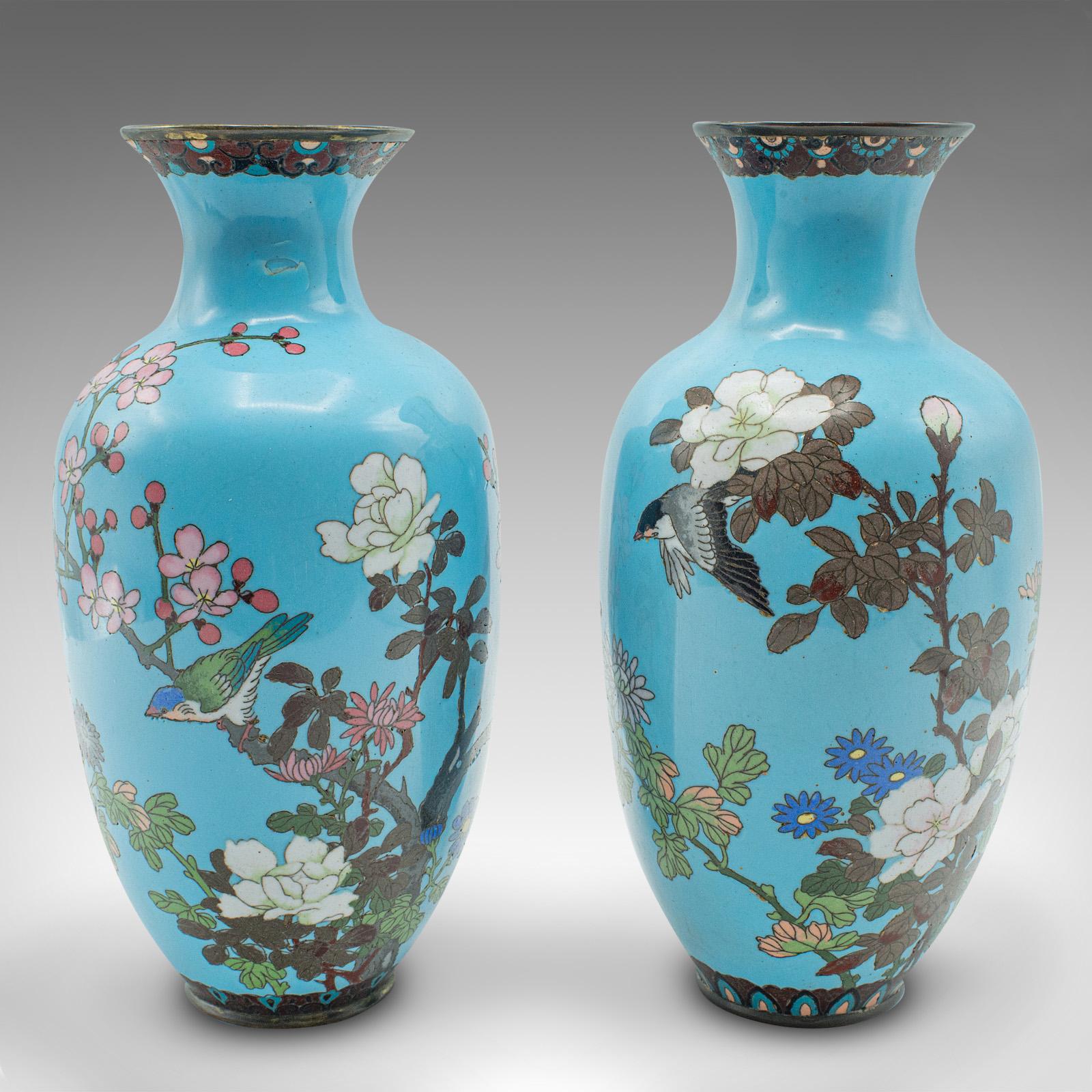 
This is an antique pair of display urns. A Japanese, cloisonné posy vase, dating to the Victorian period, circa 1870.

Delightful, early Meiji period vases with charming decor
Presenting a desirable aged patina with lightly time worn