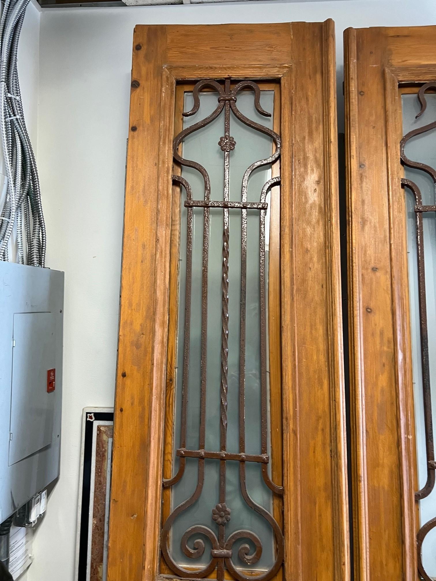 This is a great pair of antique doors wood with decorative iron panels. The pair was imported from Egypt and were produced at a time in the early 1900s when French architecture and style had a great influence on the Egyptian culture, especially in