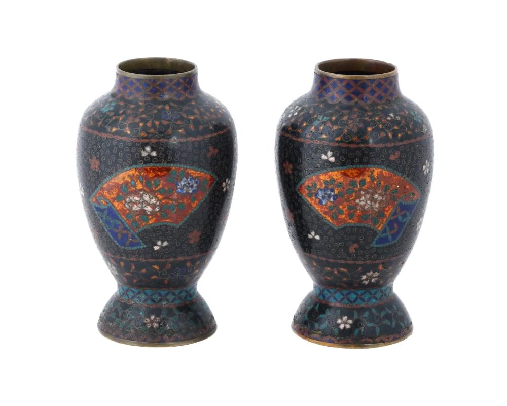 A pair of antique Japanese Early Meiji period cloisonne enamel vases attributed to Namikawa Yasuyuki. Each vase is adorned with intricate floral designs, showcasing the meticulous artistry characteristic of Namikawa Yasuyukis work. Namikawa Yasuyuki