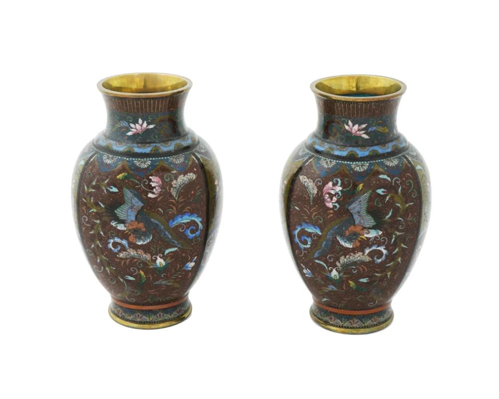 An antique Czech Bohemian blue overlay cut to clear opaline glass vase with a fluted mouth. The ware is adorned with hand enamel polychrome panels depicting medallions surrounded by floral, foliage, and scrollwork motifs, and decorated with gilded