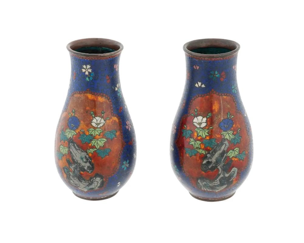 A pair of antique Japanese early Meiji period cloisonne vases, in the style of Namikawa Yasuyuki. The vases epitomize Namikawas refined craftsmanship and the finesse of early Meiji Japanese cloisonne artistry. Each vase features meticulously crafted