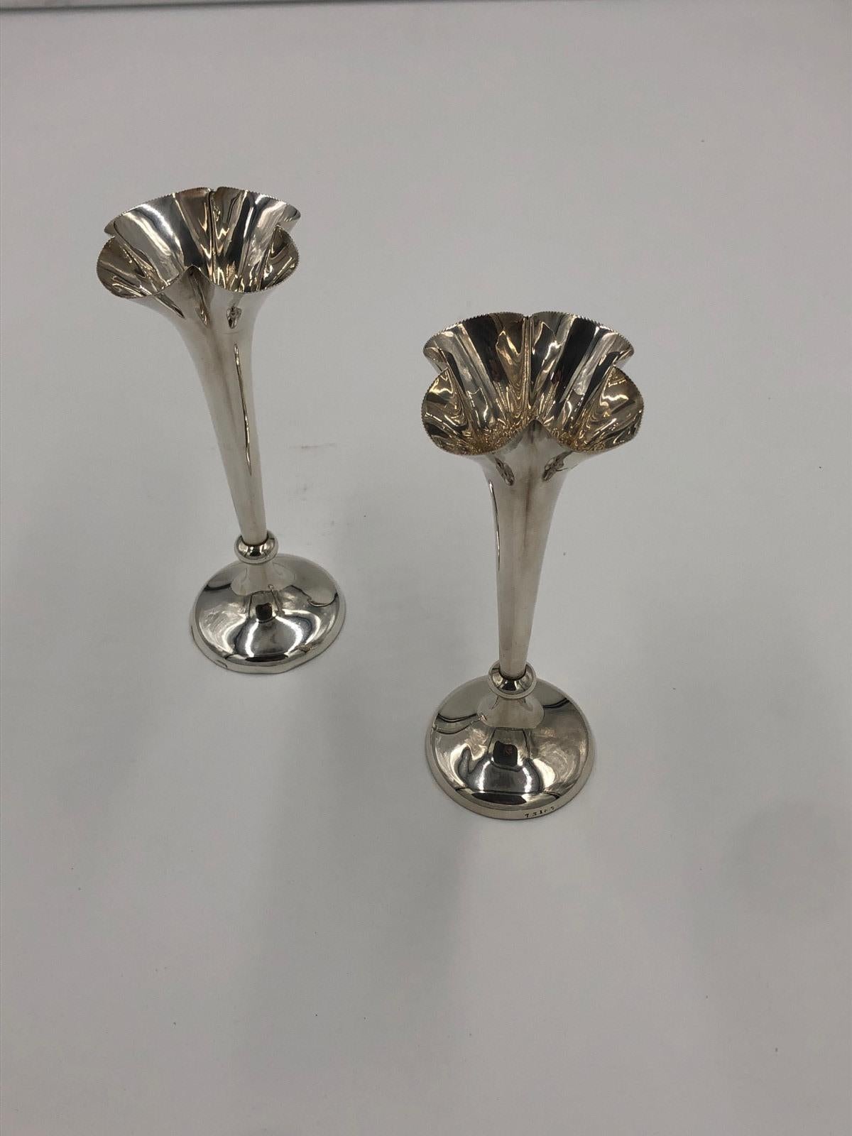 Antique pair of Edwardian antique silver spill vases having quatrefoil form beaded rims above tapering stems and standing on loaded bases. Very nice decorative items. Good condition. London 1901.