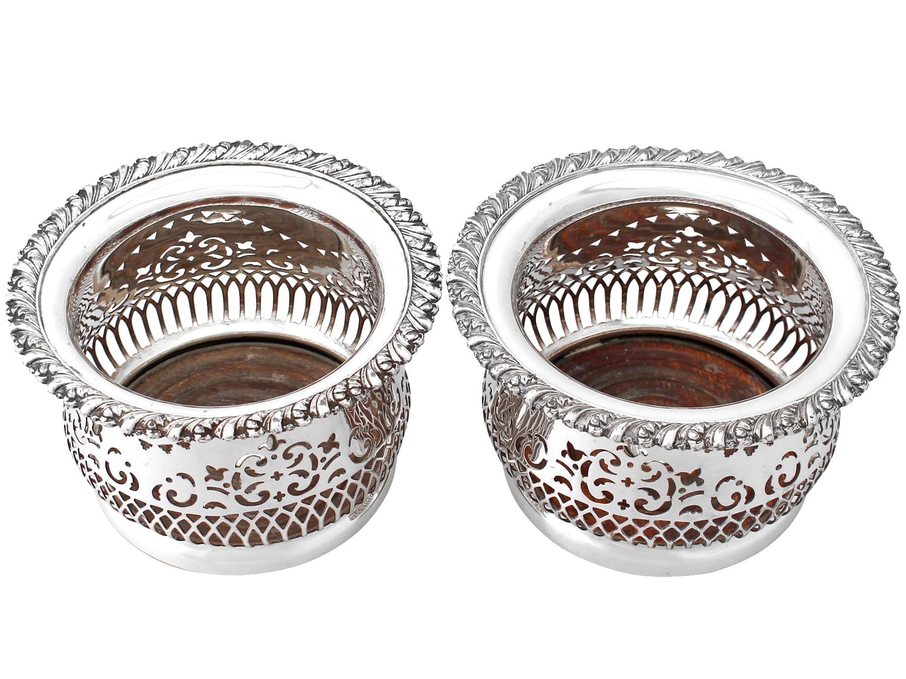 A very good pair of antique electroplated silver bottle coasters; part of our wine and drinks related collection.

These antique electroplated silver bottle coasters have a circular rounded form.

The body of each coaster is encircled with pierced