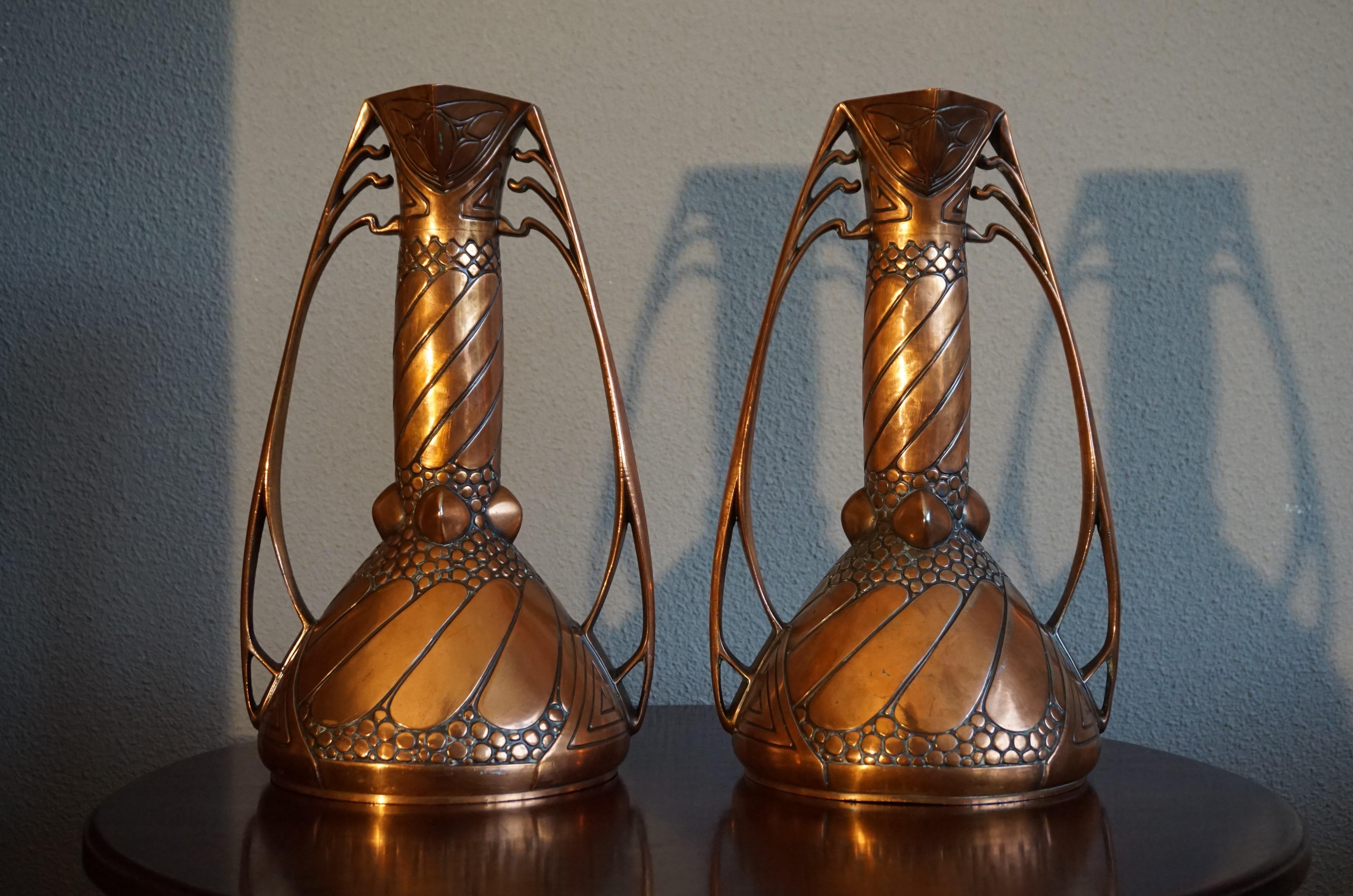 Unique and amazing workmanship pair of Arts & Crafts vases.

The design and execution of this very rare pair of Arts & Crafts vases are of the highest quality, even by the standards of Carl Deffner (1856-1948). Responsible for many excellent designs