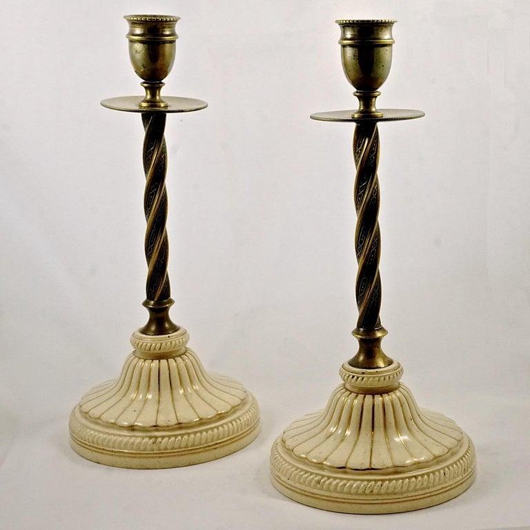 Fine pair of English Victorian detailed brass twist candlesticks, featuring beautiful cream and gold porcelain bases. The candlesticks are height 23cm / 9 inches, and the diameter of the base is 10.4cm / 4.1 inches. 

The English pottery diamond