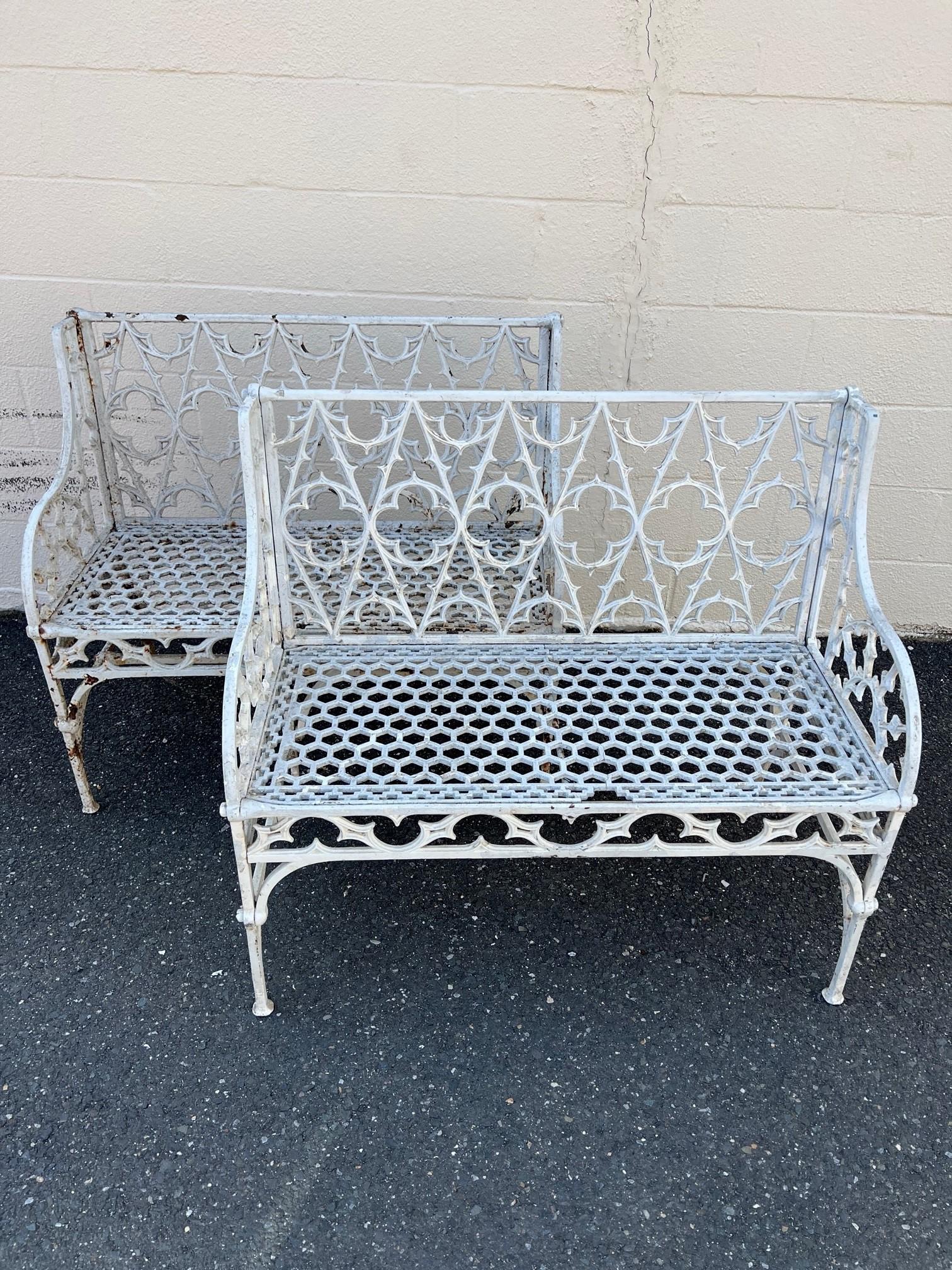 Pair of English Coalbrookdale foundry style iron gothic revival garden benches. Made in the dramatic gothic revival taste featuring a gothic tracery backrest centered by quatrefoil designs simple stunning. The seat has a honeycomb pierced design
