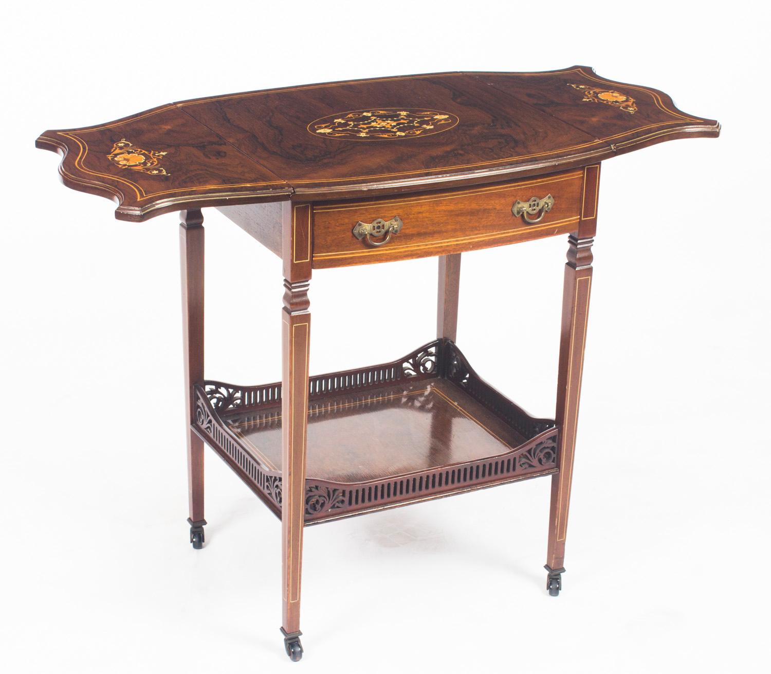 This is a wonderful pair of antique English shaped-oval gonçalo alves marquetry inlaid occasional tables, late 19th century in date.

The tables are beautifully inlaid in the elegant Edwardian manner with satinwood and ebonized crossbanded