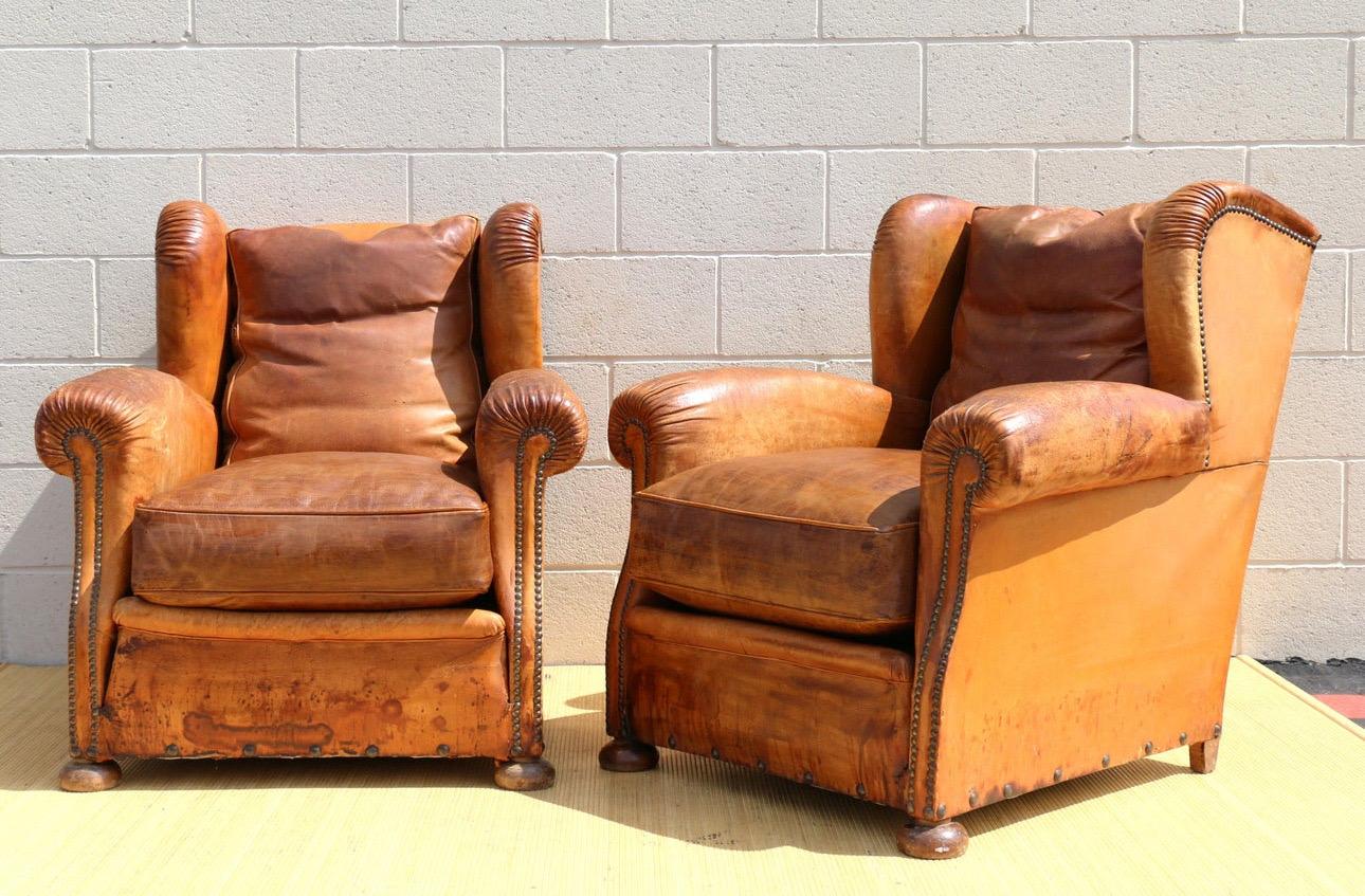 French Provincial Antique Pair of French Art Deco Distressed Brown Leather Wingback Lounge Chairs For Sale