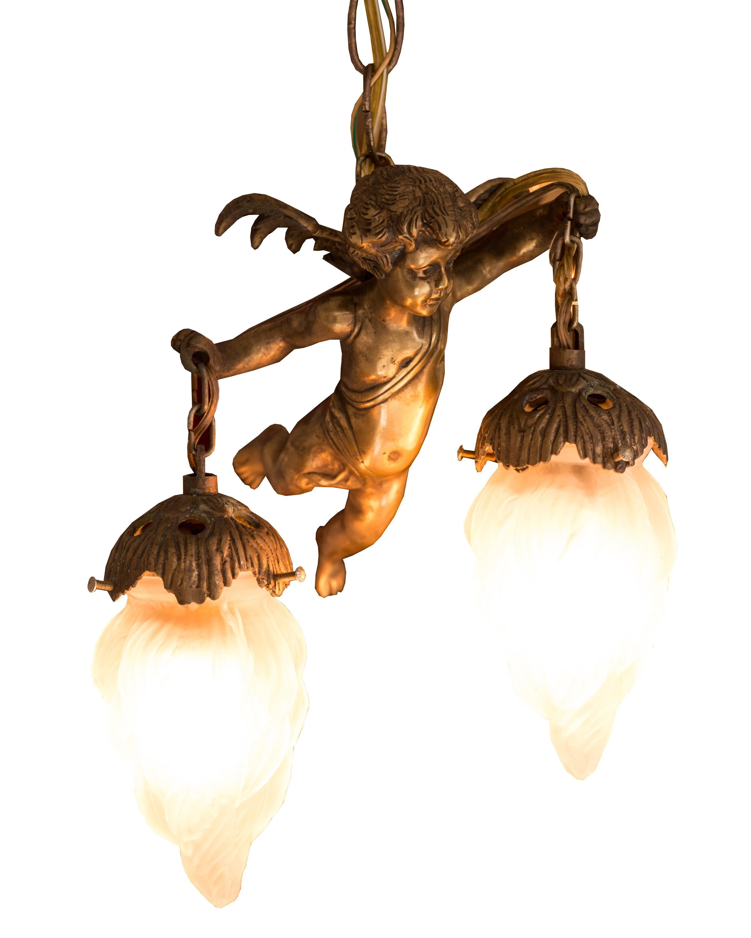 These whimsical antique bronze cherub pendants are truly divine. Each solid bronze cherub holds a frosted flame shaped bulb covers from each arm and is suspended from the ceiling by 3 feet of matching chain. We envision these pendants hanging over