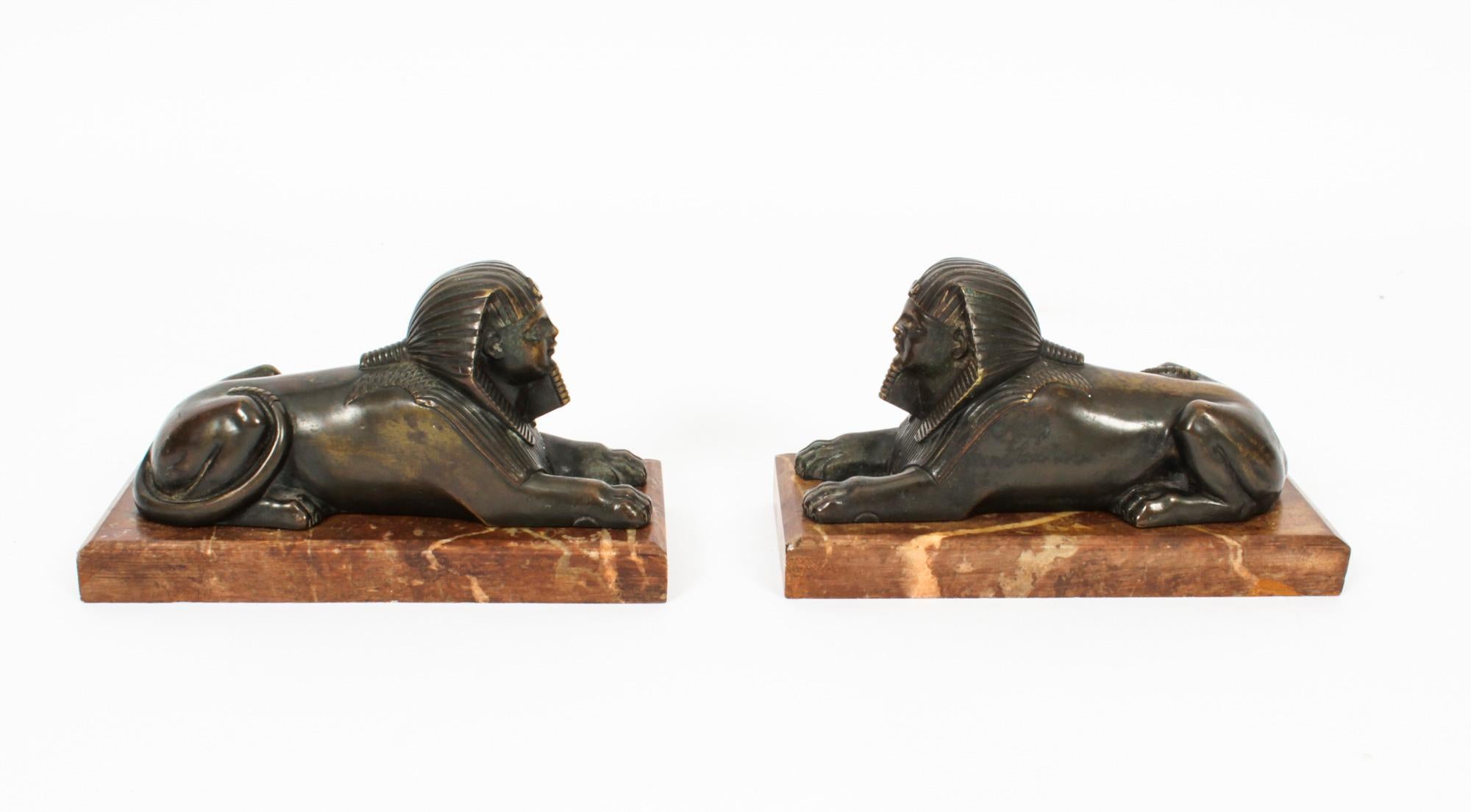 This is a beautiful antique pair of French patinated-bronze sculptures of recumbent Sphinx, Circa 1860 in date.
 
Each sphinx is modelled with a pharaonic headdress on a man's head with a lions body.

Both statues have a lovely dark brown