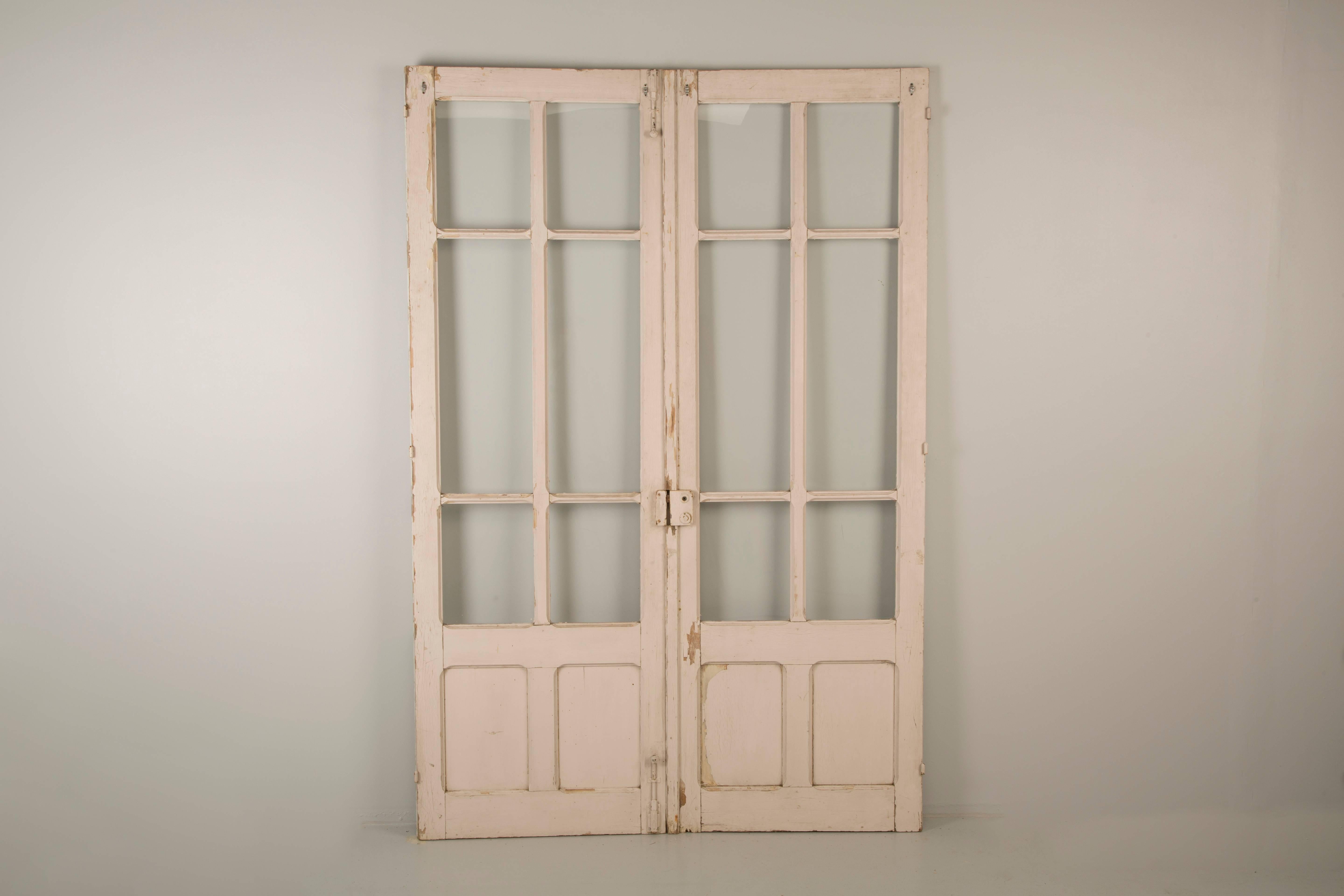Antique pair of French original paint doors, from the French Provence region. We left the antique French doors in their original, as found condition, so that they can be used as is, or refinished to suit your particular needs. Not sure how the color