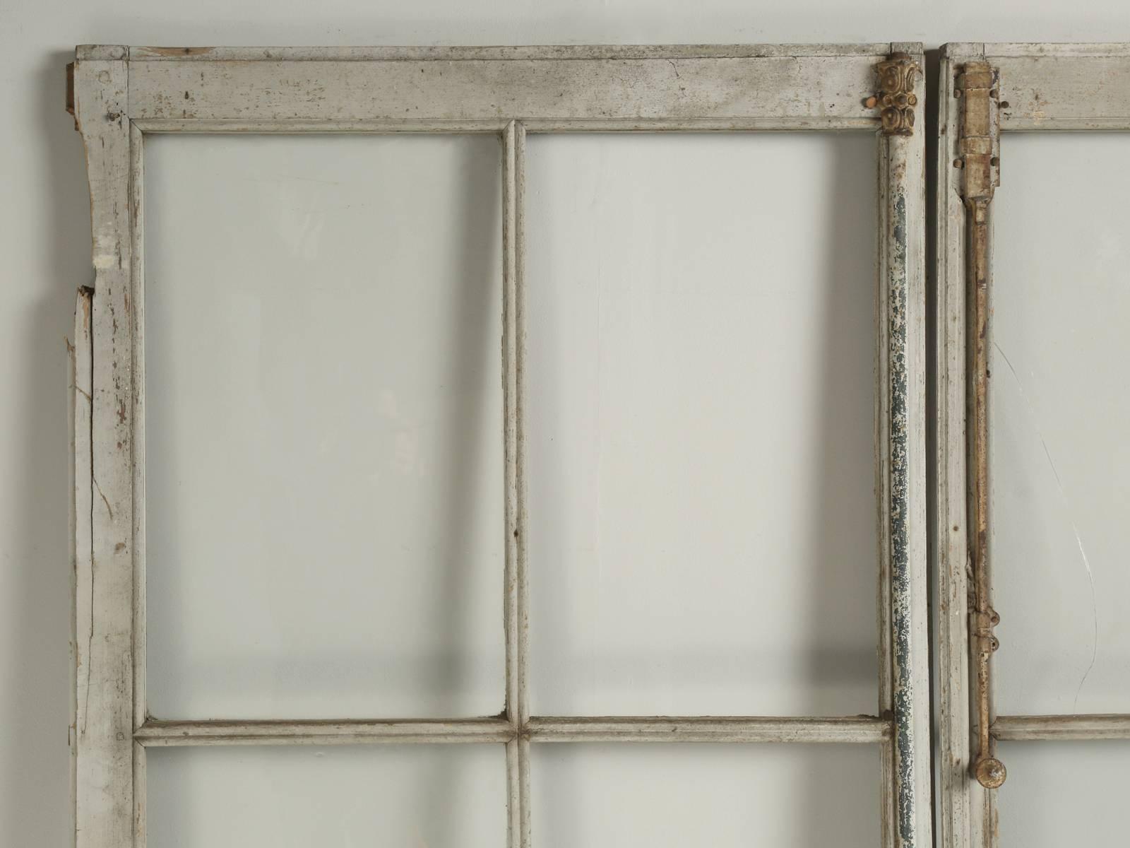 Wonderful pair of extremely tall at 9’ 5” antique French doors in their original paint. We have not touched the doors, other than to clean the glass and lightly brush off the dust from decades of storage in the south of France. Please note, there