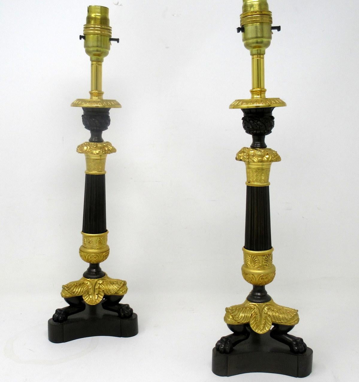 An exceptionally fine pair French Ormolu and bronze early Victorian single light candlesticks of small proportions, now converted to a stunning pair of electric table lamps, offered in exceptional condition, each with unusual reeded central bronze