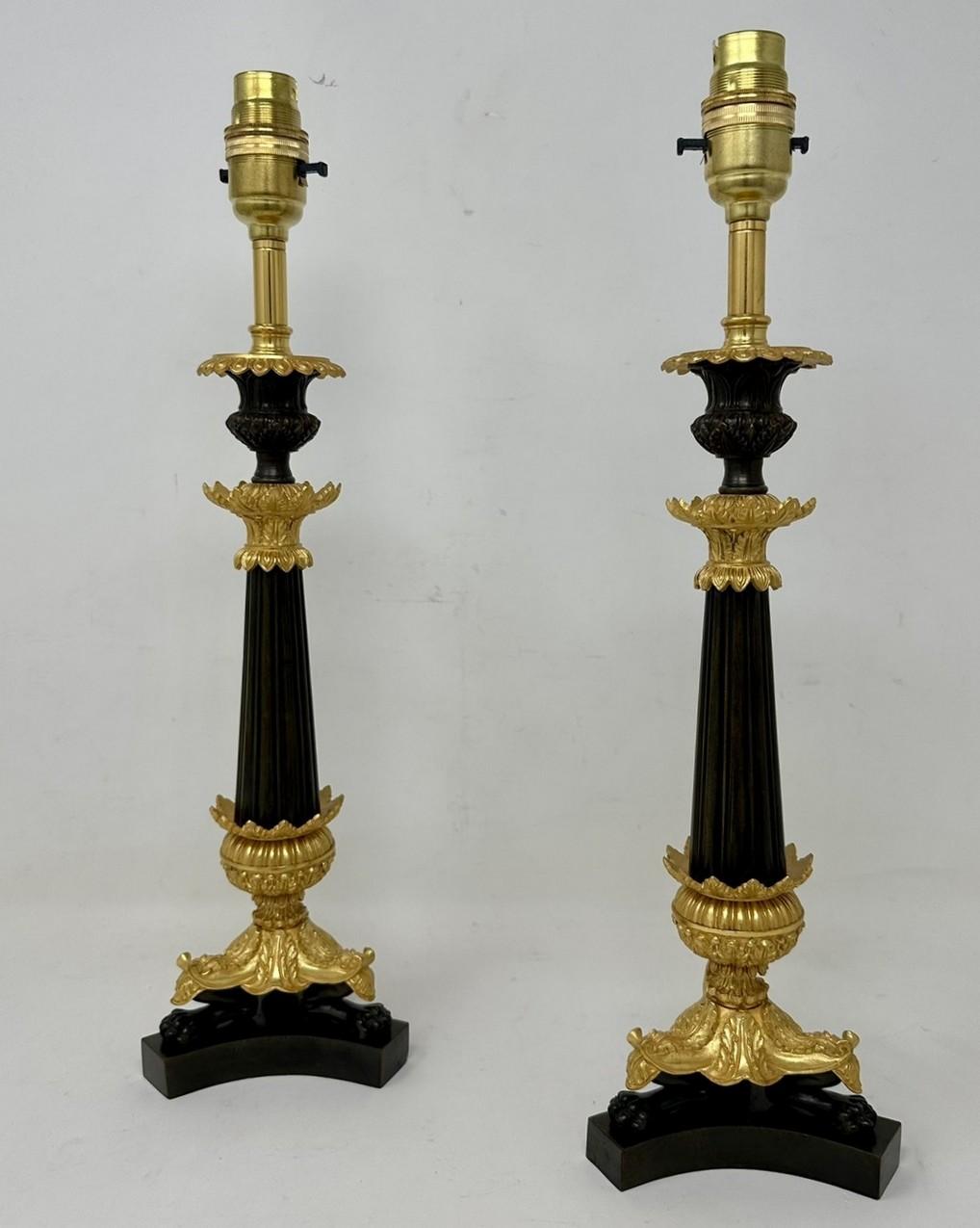 Stunning Identical Pair French Heavy Gauge Ormolu and Bronzed Single Light Candlesticks of average size proportions, now converted to a Pair of Electric Table Lamps, with tapering reeded central bronzed column, each ending with three very ornate