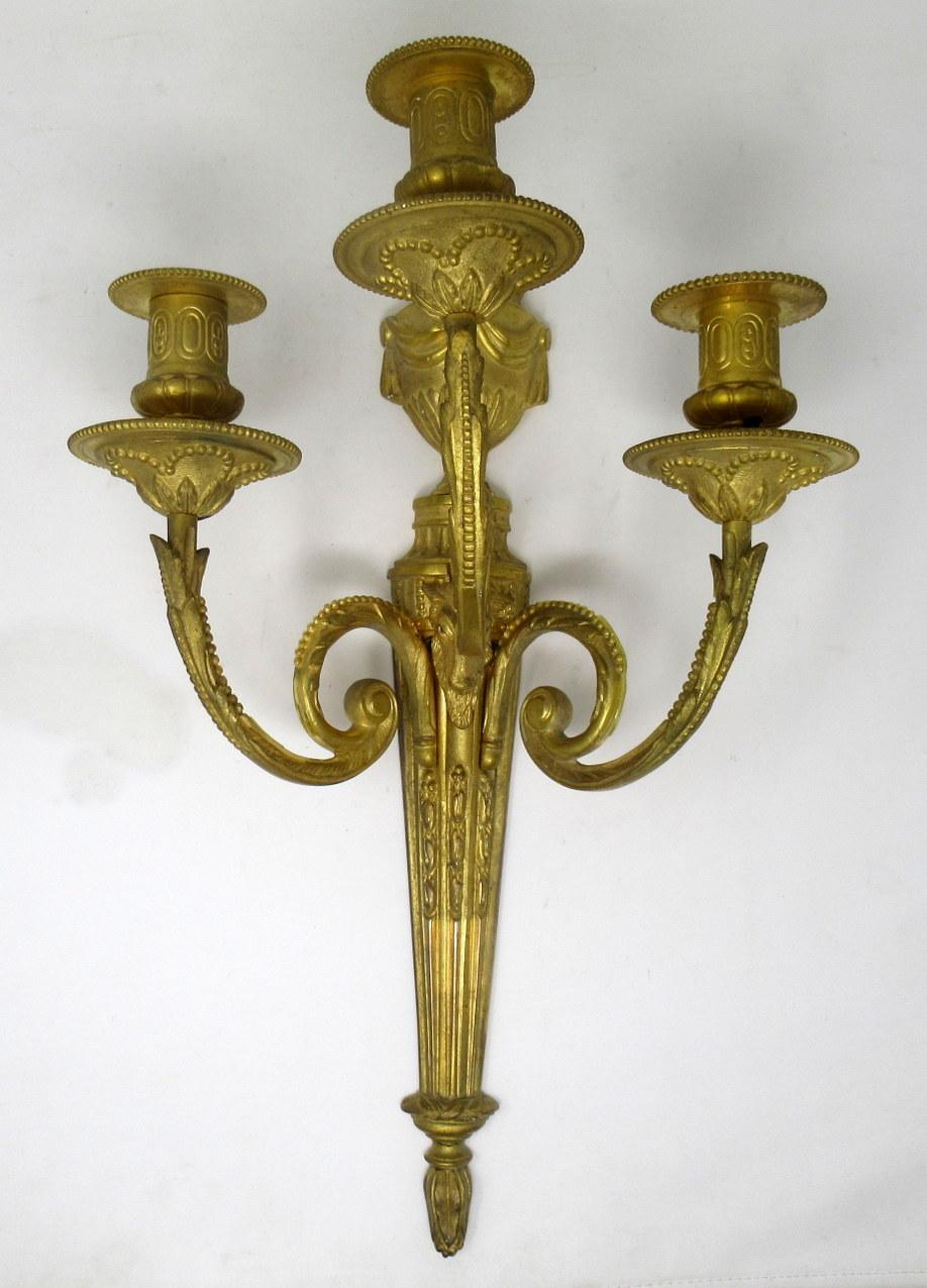Fine quality pair of French well cast heavy gauge gilt bronze three-arm wall candle sconces lights, of generous proportions, late 19th century, early 20th century. 

The three leaf capped scroll arms issuing from a single goat head above a
