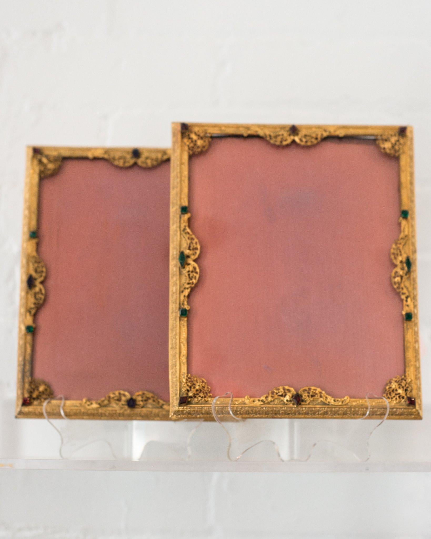 A pair of French antique gold picture frames with filigree work and jewels backed in pink silk. This frame is as precious as the memory you may fill it with. Fits a 7