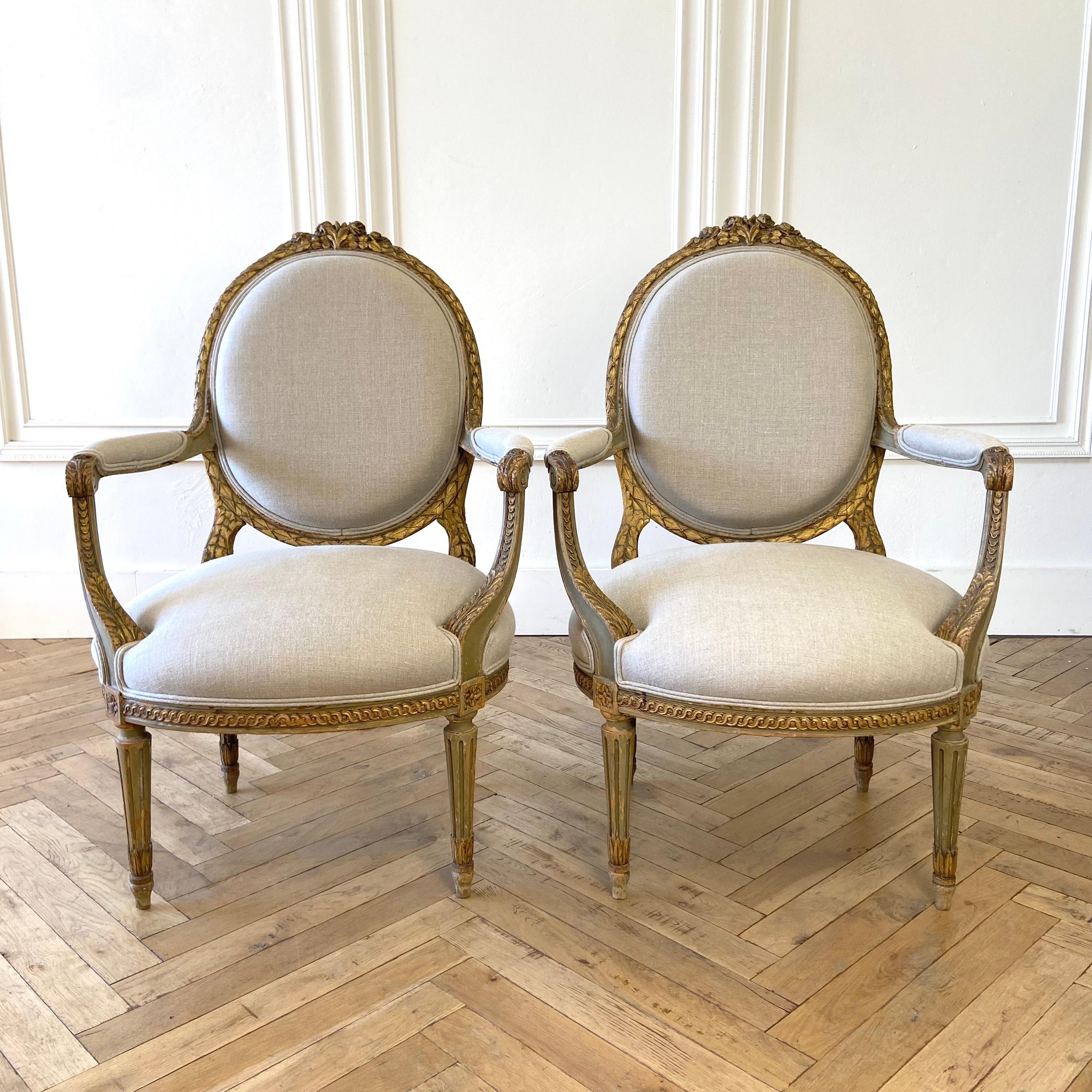 Pair of Antique original paint and giltwood open arm chairs
Painted in the grayish-green with gold gilt, subtle aged patina is natural from use and age. Reupholstered in Libeco Organic Flax heavy weight linen, finished with a welt.
Solid and
