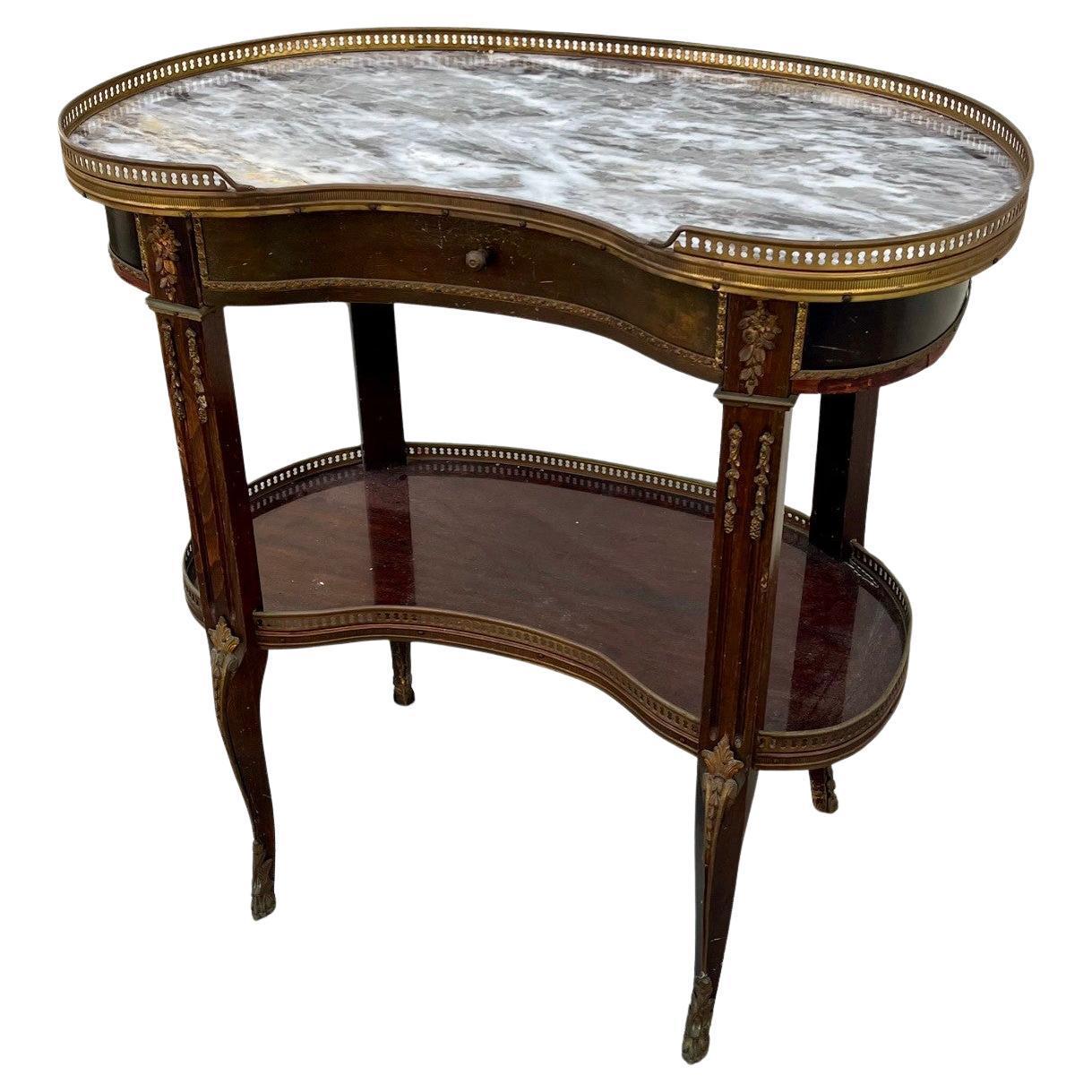 Antique Pair of French Louis XVI Style Side Tables 19th Century

Pair of French Louis XVI transitional kidney shaped side tables with bronze mounts, are fitted with a single drawer. The veneered, delicate tables are outfitted with a bottom shelf,