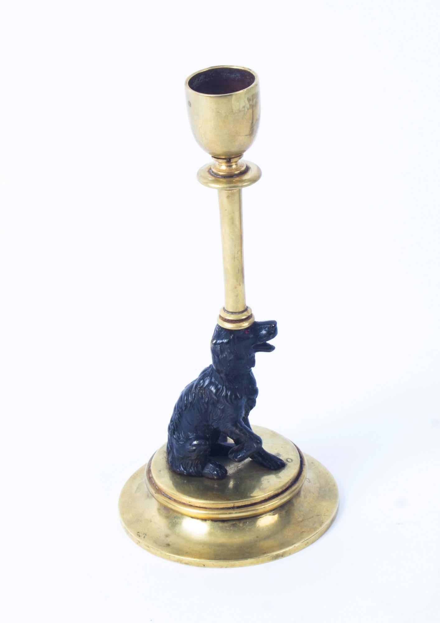 This is a delightful antique pair of 19th century French bronze Spaniel candlesticks, circa 1870 in date.

The candlesticks feature dark patinated and polished bronze spaniels,

Each has an annular sconces on a tall stem, supported by a seated