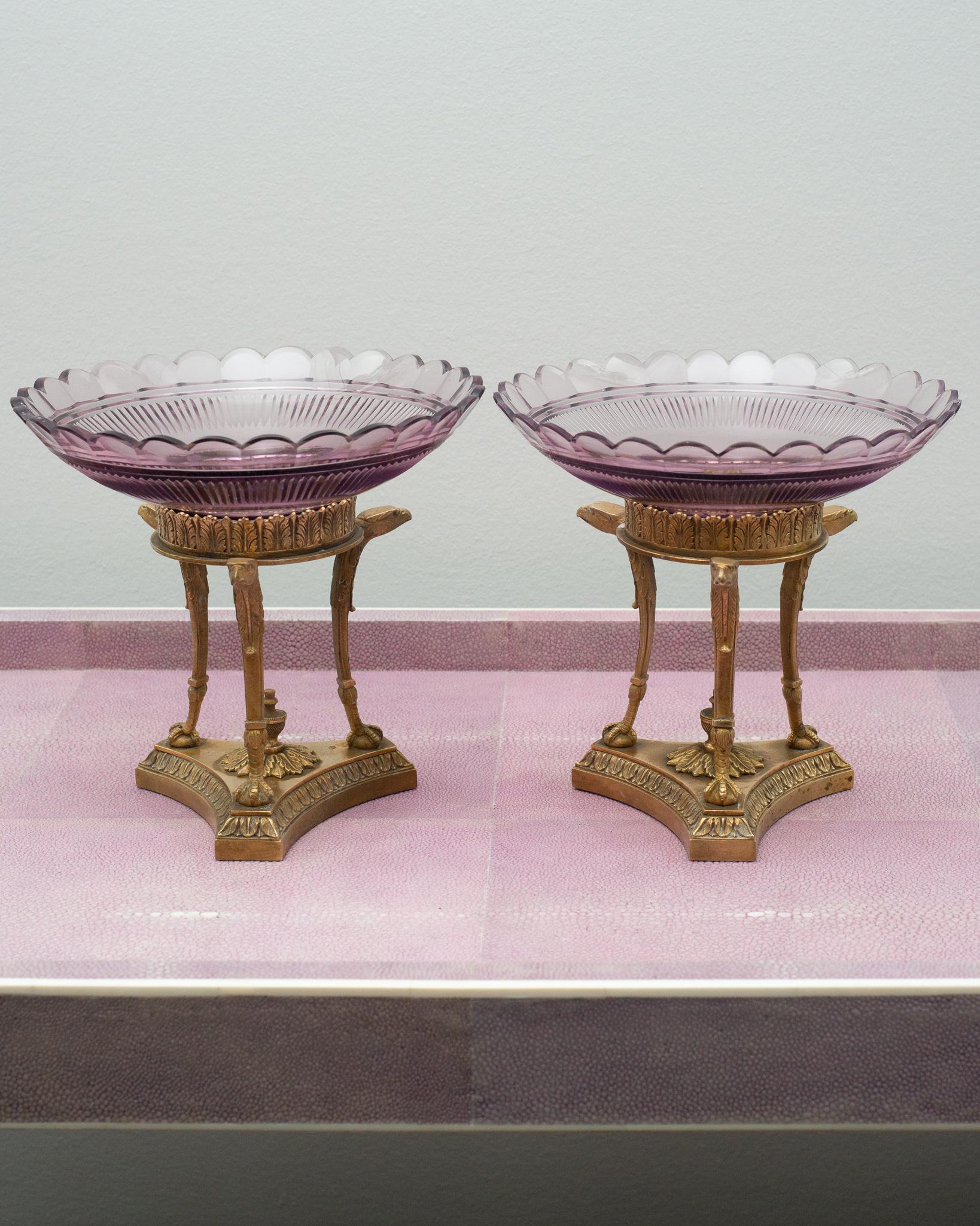 A beautiful pair of antique French compotes / tazzas / bowls with bronze mount featuring Griffin motif. Both bronze and crystal are in very good condition for their age. The light purple crystal is expertly hand cut with radial decoration and