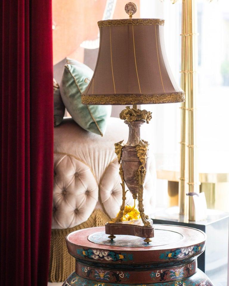 A stunning pair of antique French table lamps, expertly crafted from rich purple marble and adorned with intricately detailed bronze mounts. These exceptional 19th-century lamps embody the elegance and refinement of classic French design, making