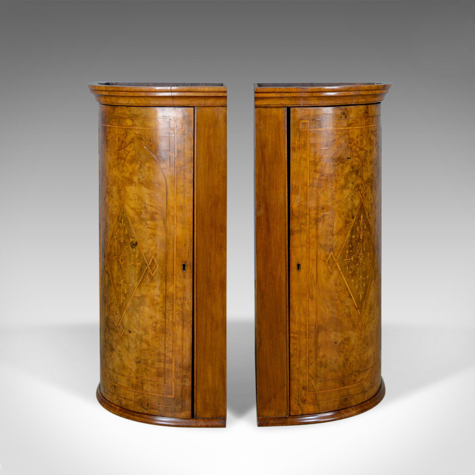 This is an opposed antique pair of Georgian revival corner cabinets. English, burr walnut hanging cupboards dating to the Edwardian period of the early 20th century, circa 1910.

Highly desirable opposed pair of cabinets
Well figured burr walnut