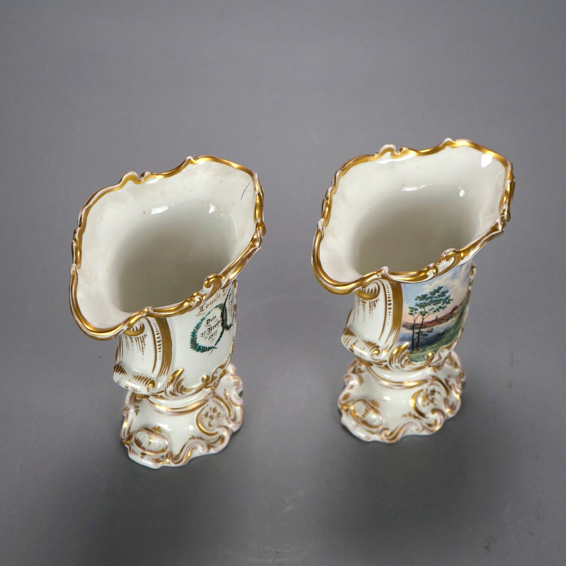 An antique pair of German vases offer porcelain footed construction with scroll form lip over hand painted scenic reserves, gilt highlights throughout, maker stamped inside base as photographed, 19th century

Measures- 8''H x 7''W x 5''D.