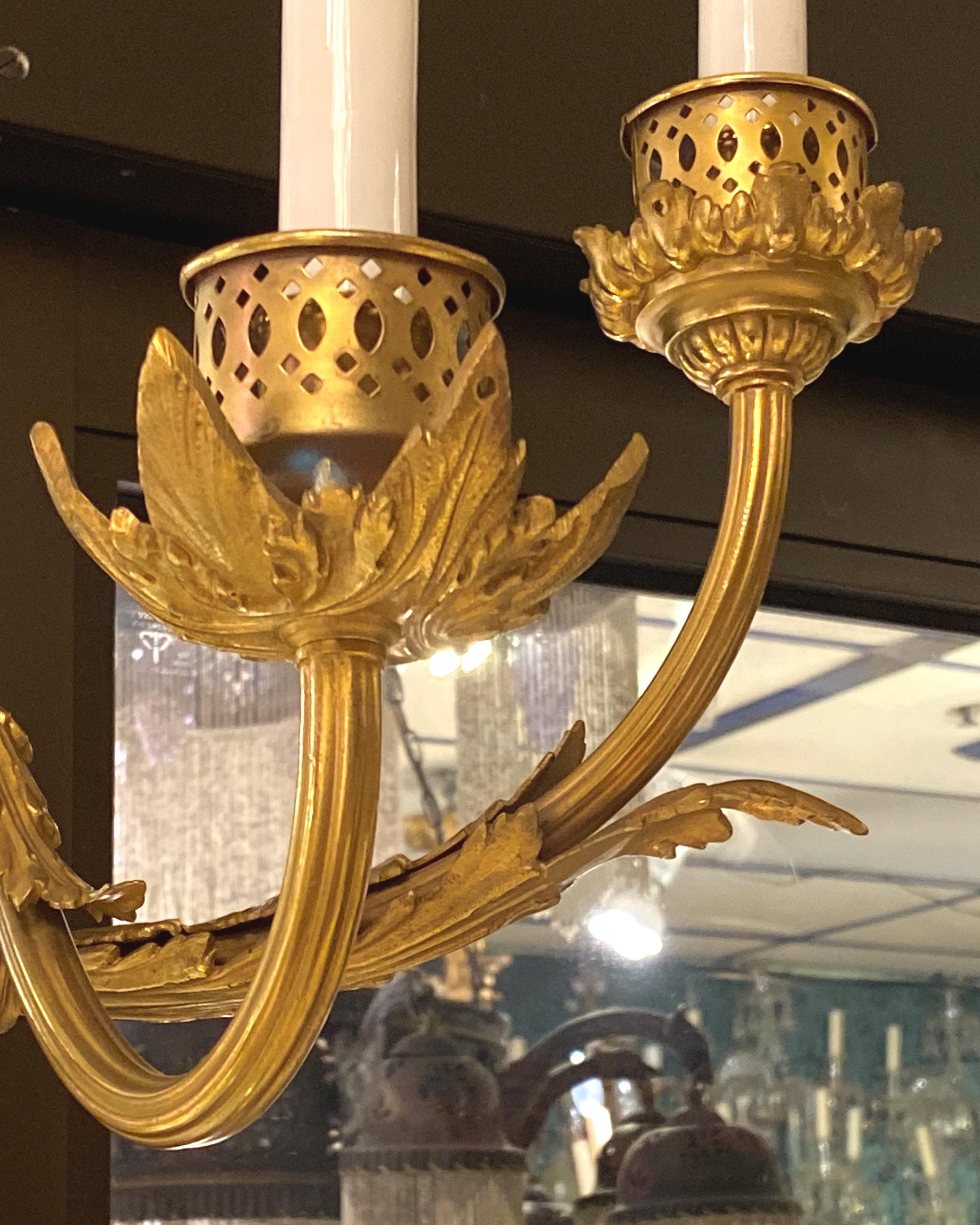 Pair of very large, antique (late 19th to early 20th century) blue enameled and gilt bronze sconces (wall lights) in the French Louis XVI style with three electrified candles, with modern sockets and wiring, ready for use.  Each 35 by 14 by 6 inches.