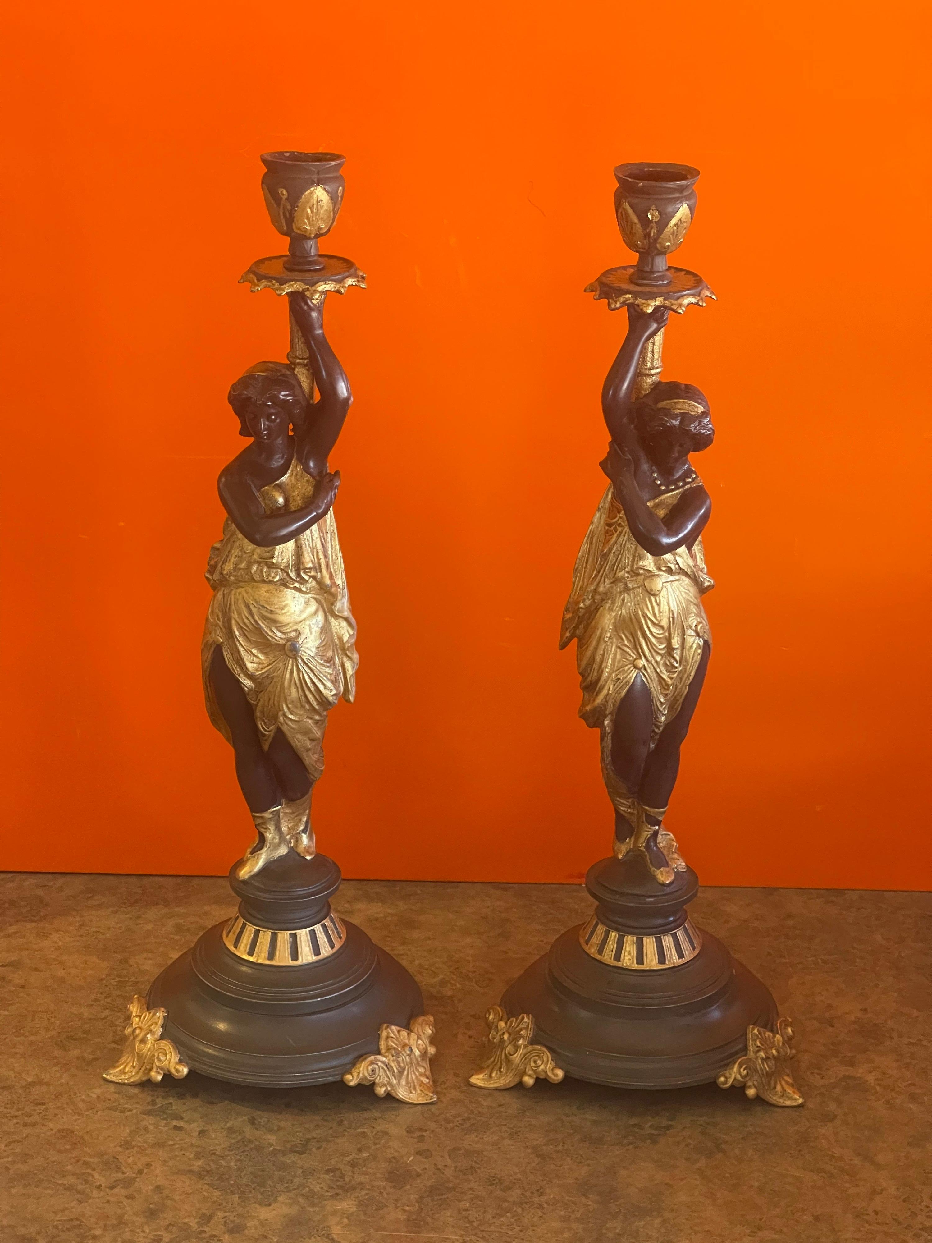 Elegant pair of antique gilt bronze figurative candlesticks, circa 1930s. The pair are in very good vintage condition with nice patination; they measure 5.5