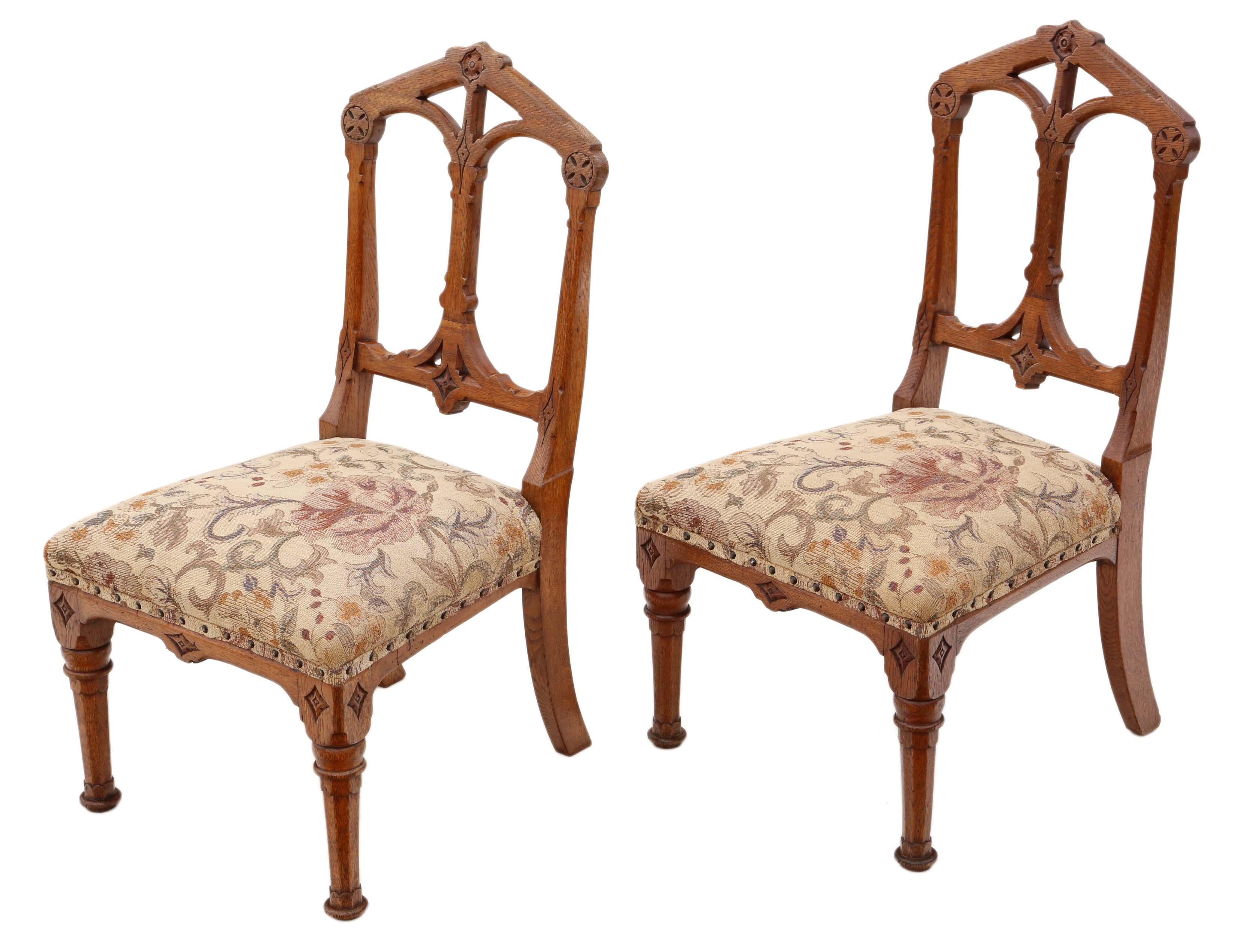 Antique quality pair of Gothic revival oak side hall bedroom chairs C1880. Lovely light golden colour to the oak frames and a fantastic Gothic design.

Solid, with no loose joints.

The upholstery is not new, but has no significant wear or major