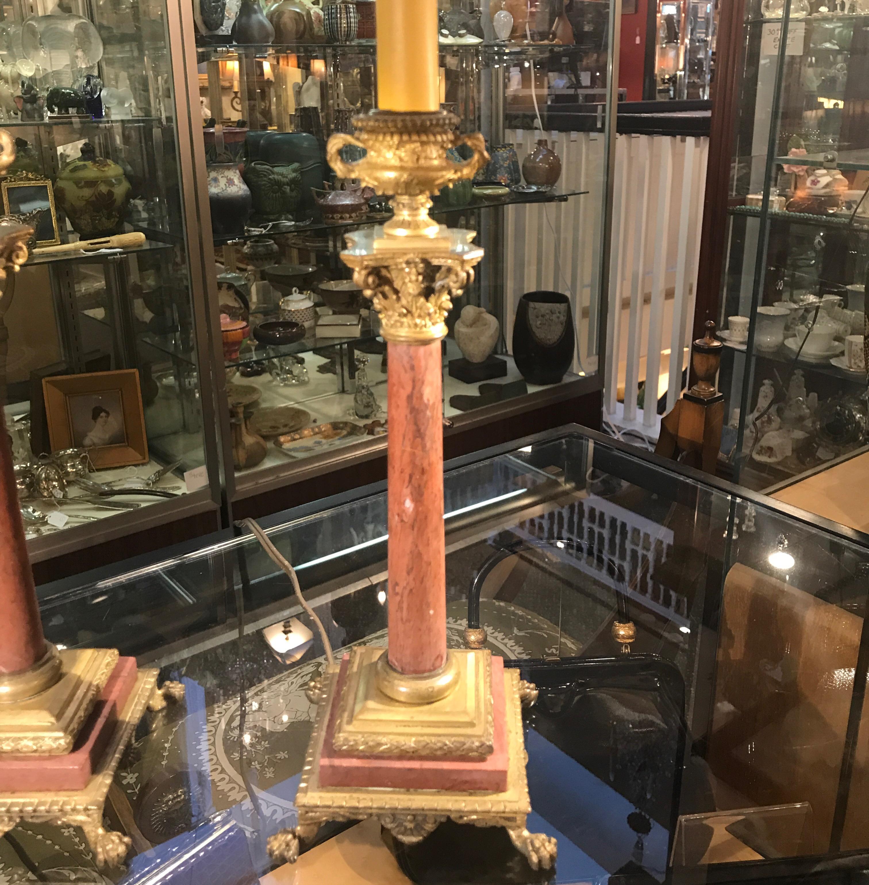 A pair of antique Rouge French marble candlestick lamps with cast gilt bronze mounts. The candlesticks with finely cast column tops and bronze mounted square plinth bases. The sticks are mid-19th century with new hardware and wiring. 20 inches high,