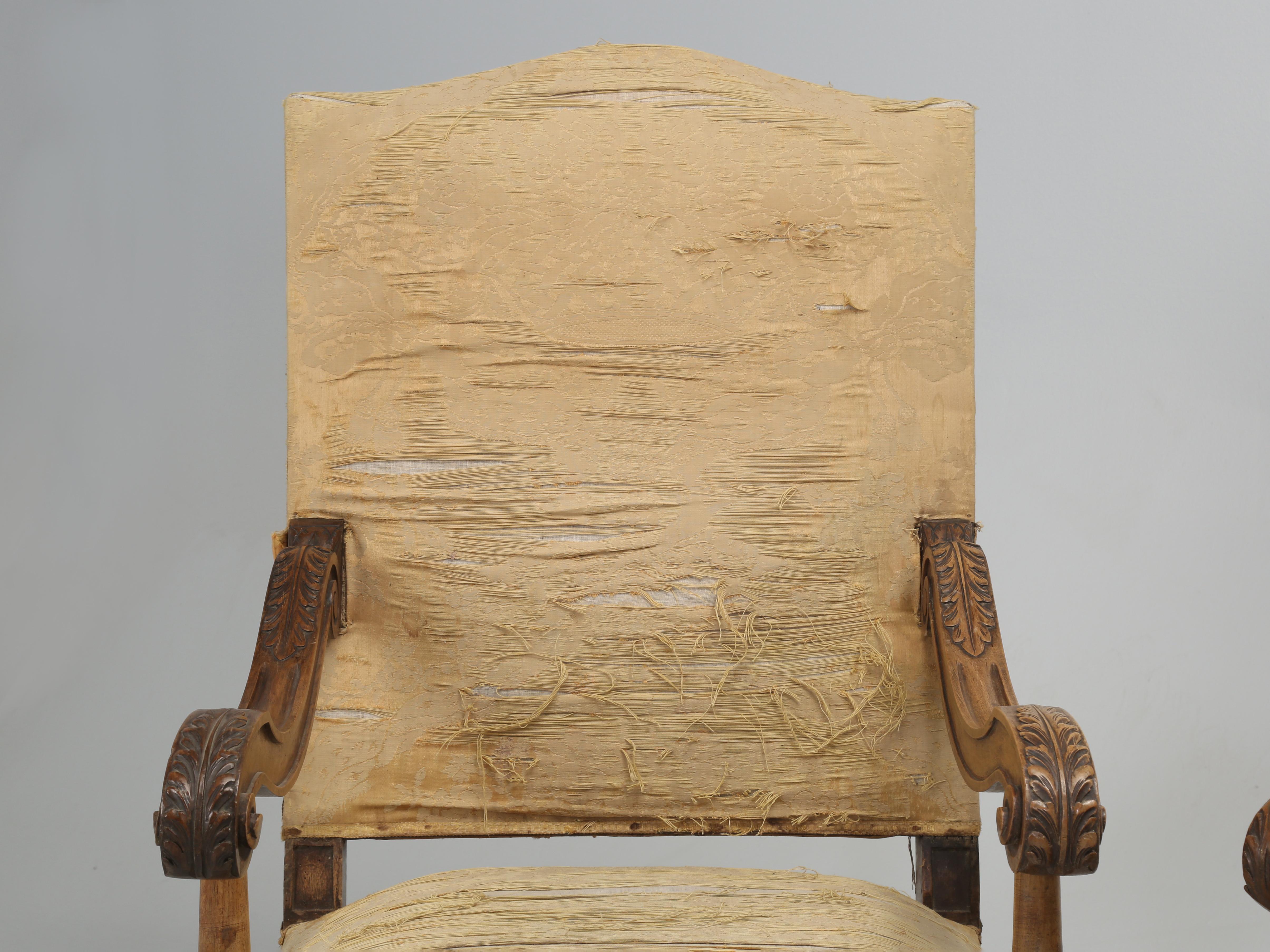 Antique Italian pair of armchairs that were hand carved from solid Walnut and in desperate need of restoration. We have (2) pairs of Matching Italian Armchairs that must have come out of the same Italian home and all are in dire need of a full