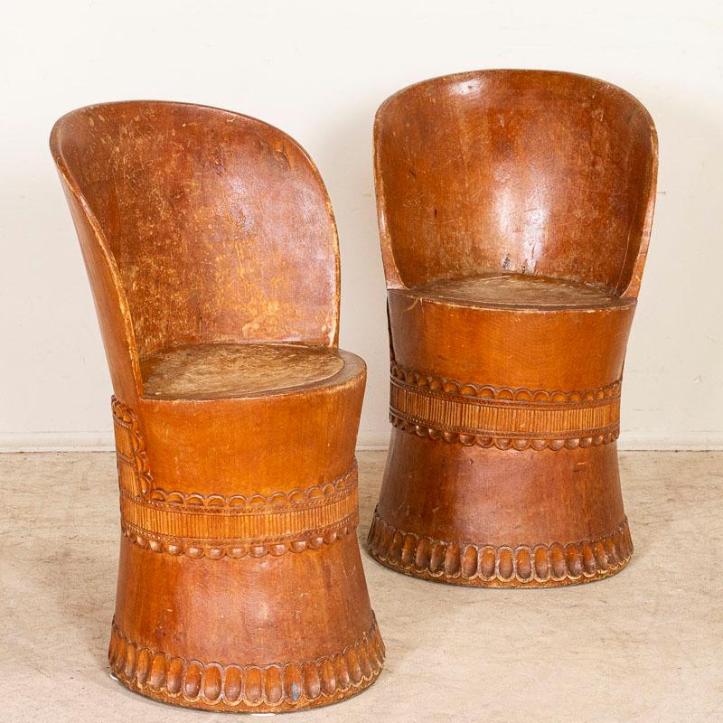 A kubbestol is a traditional Scandinavian chair made from a single log. While these unique folk-art chairs can be difficult to locate, a pair makes these a special find. Notice the hand-carved details around the base, gently curved back and