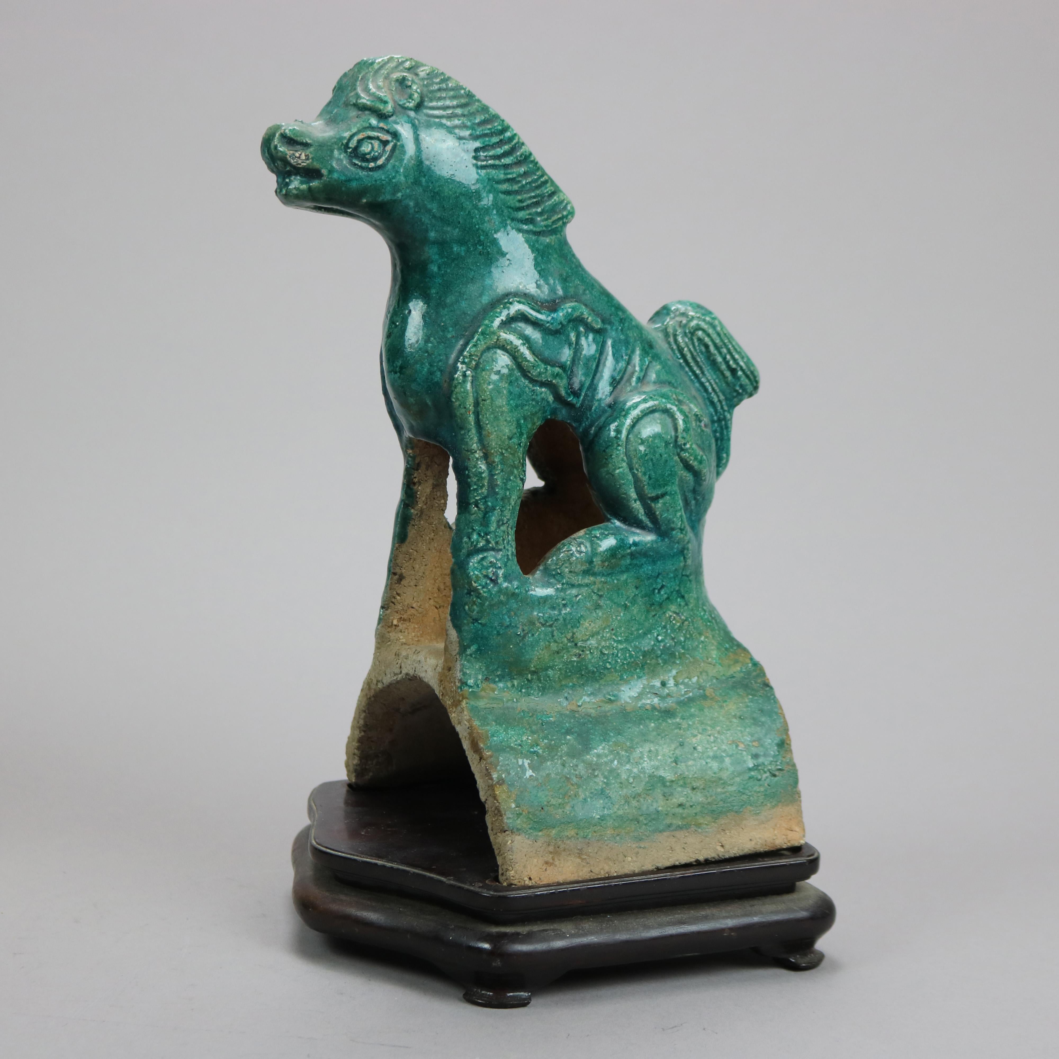An antique pair of large Chinese figures offer hand made terra cotta horse figures glazed in green and seated on hardwood plinths, 19th century

Measures - 11.5''H x 6''W x 6.5''D.