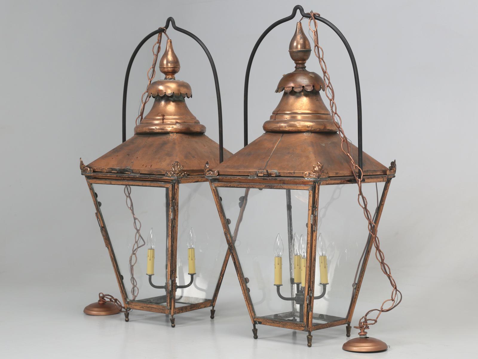Antique pair of large French copper lanterns, that we imported from France and properly restored in our old plank workshop electrical department; we even fitted the antique pair of French copper lanterns, with handmade French wavy glass and of