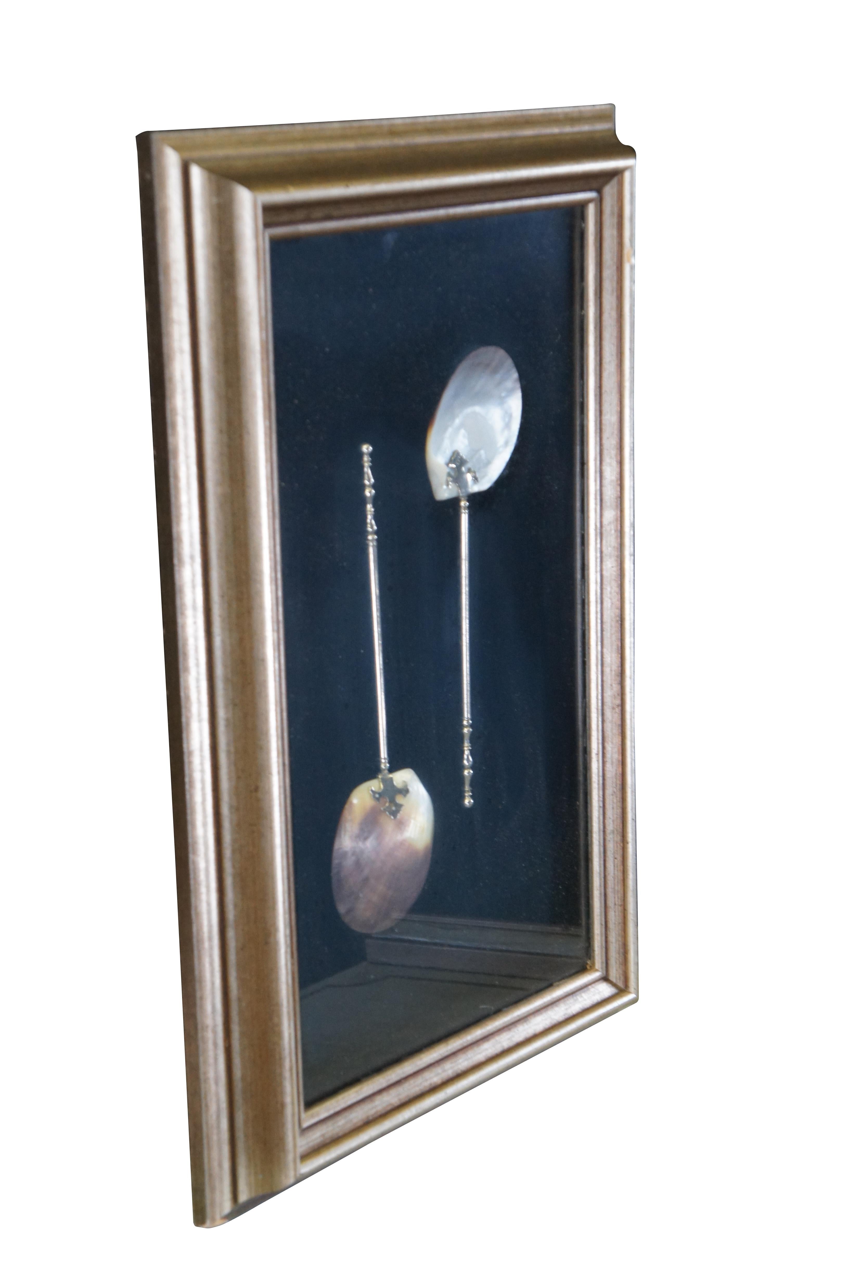 Beautiful pair of antique mother of pearl shell servings spoons with silverplate handles.  The spoons are neatly framed in a shadowbox behind glass.  

Dimensions:
20