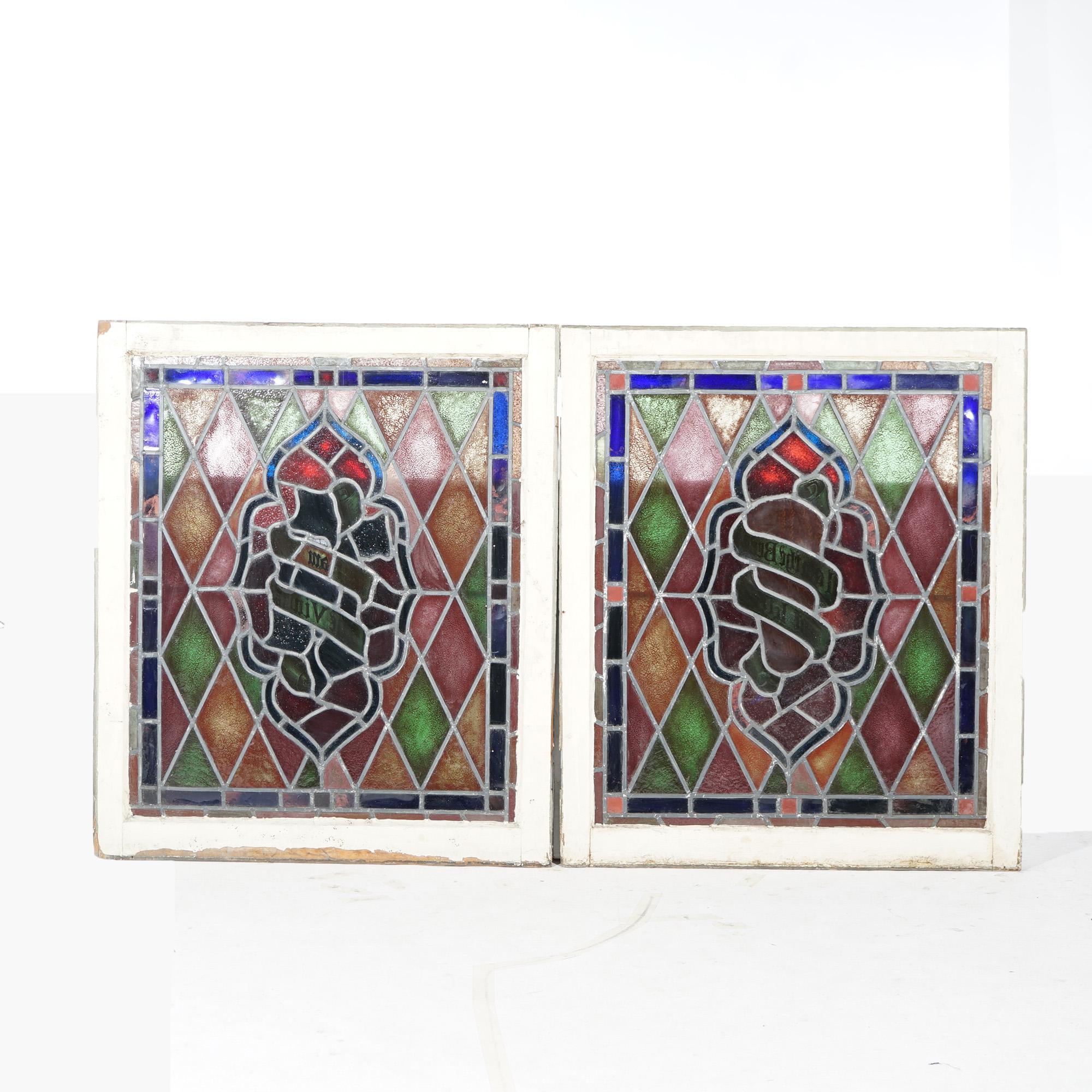 An antique pair of Arts and /crafts windows offer leaded stained glass construction with stylized foliate central design in argyle ground, seated in wood sash, c1900

Measures - 41.75