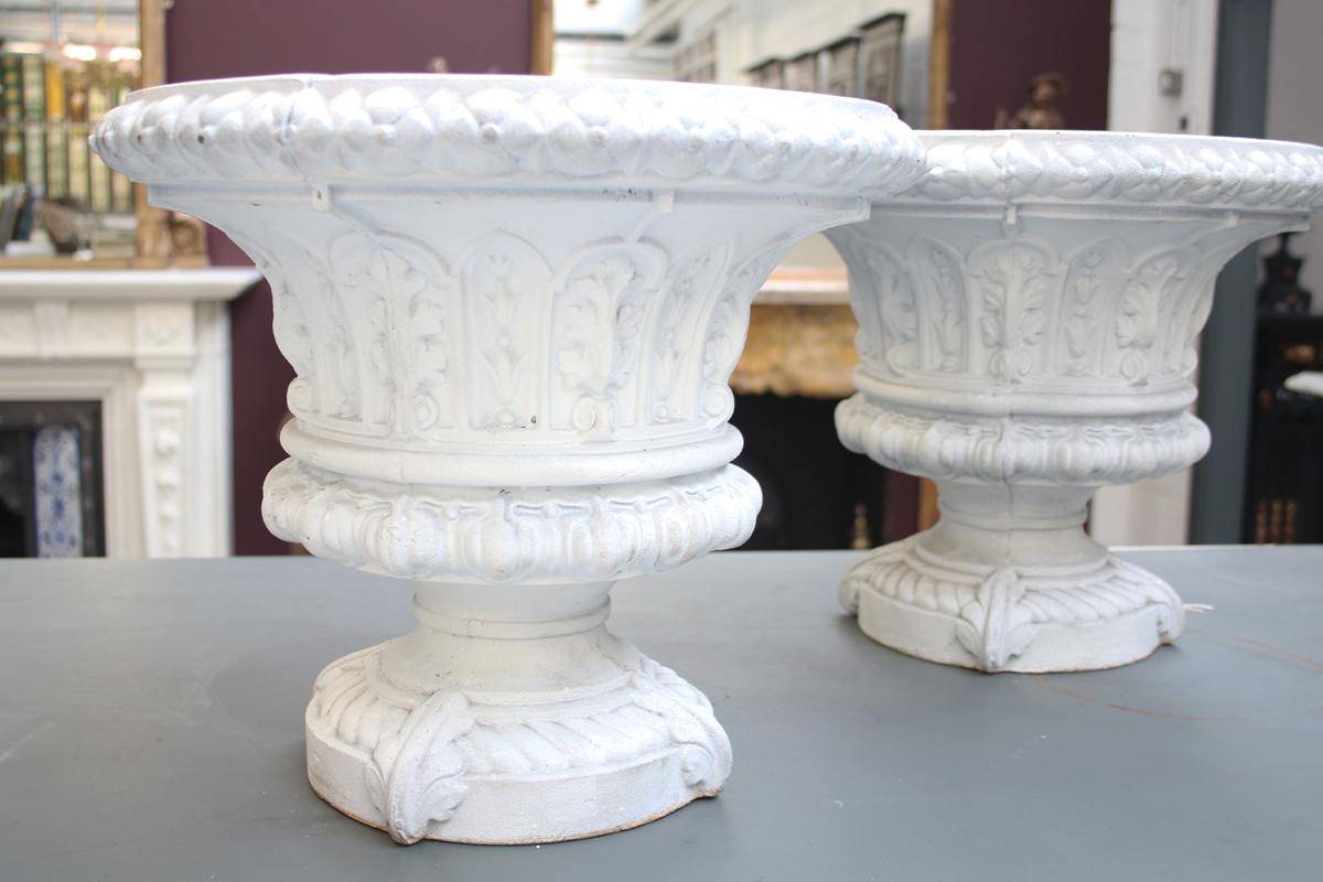 Antique pair of small mid-Victorian cast iron garden urns with fine decoration. Primed ready for painting.

Overall 15.5