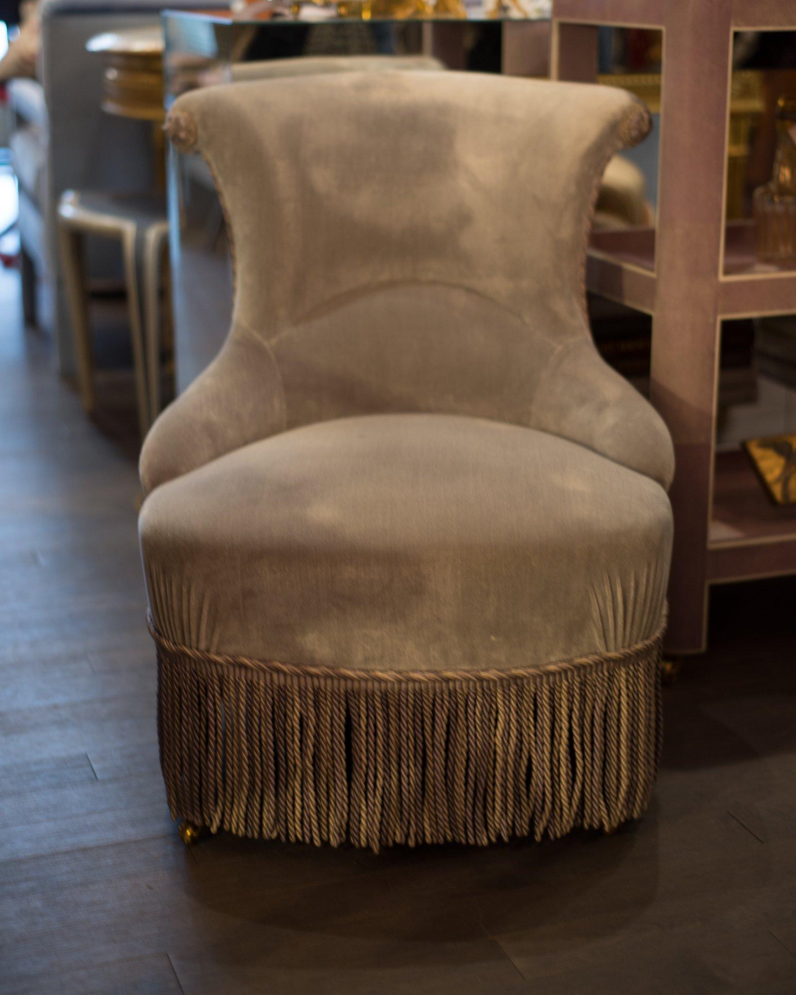 A pair of elegant 19th century antique French Napoleon III slipper chairs adorned with rich bullion fringe, rope and rosettes from Samuel & Sons. Beautifully restored and upholstered by a master upholsterer, who has been diligent to maintain the