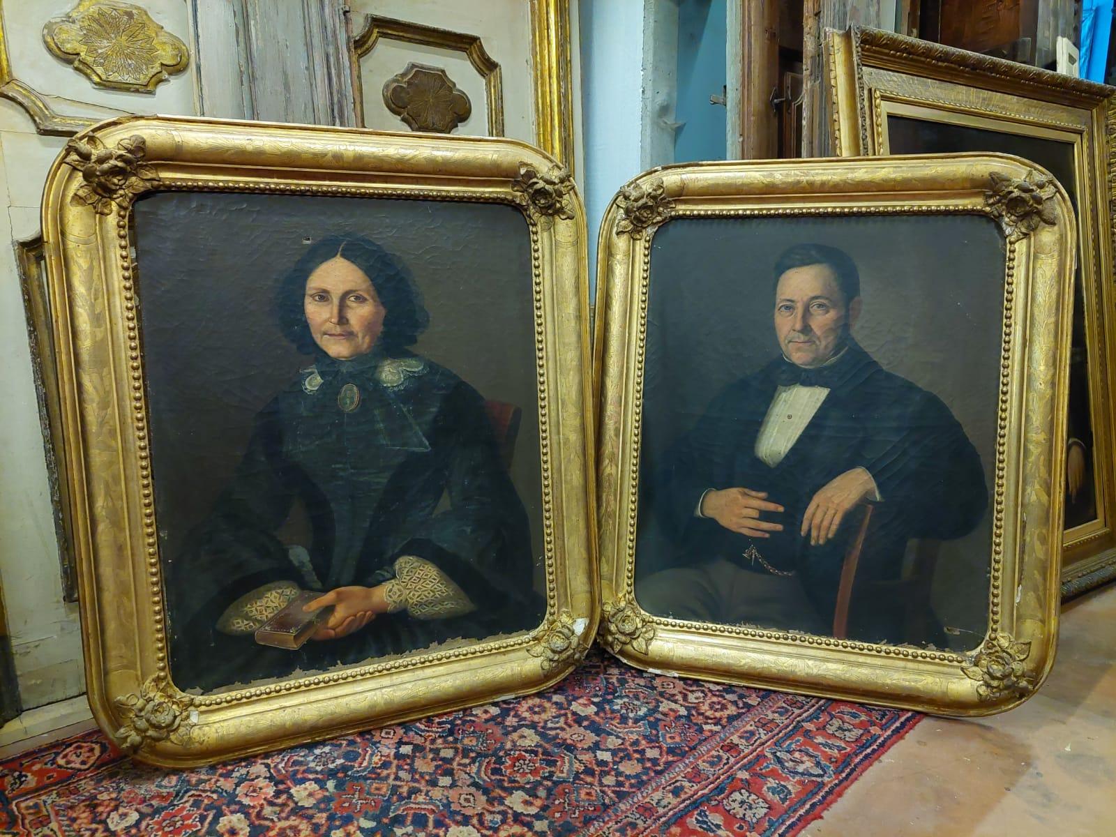 Ancient pair of oil paintings on canvas, depicting ancestors with period clothes and enriched by a golden frame, richly sculpted with roses and coeval with the painting, original, painted in the 19th century, measure in cm W 85 x H 102 x D 6.